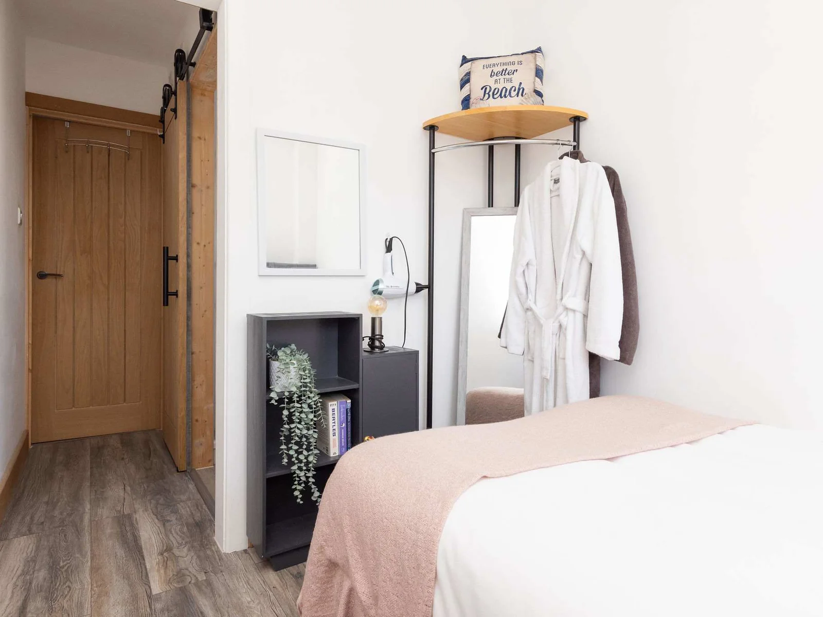 Compact bedroom with mirror and robe hooks