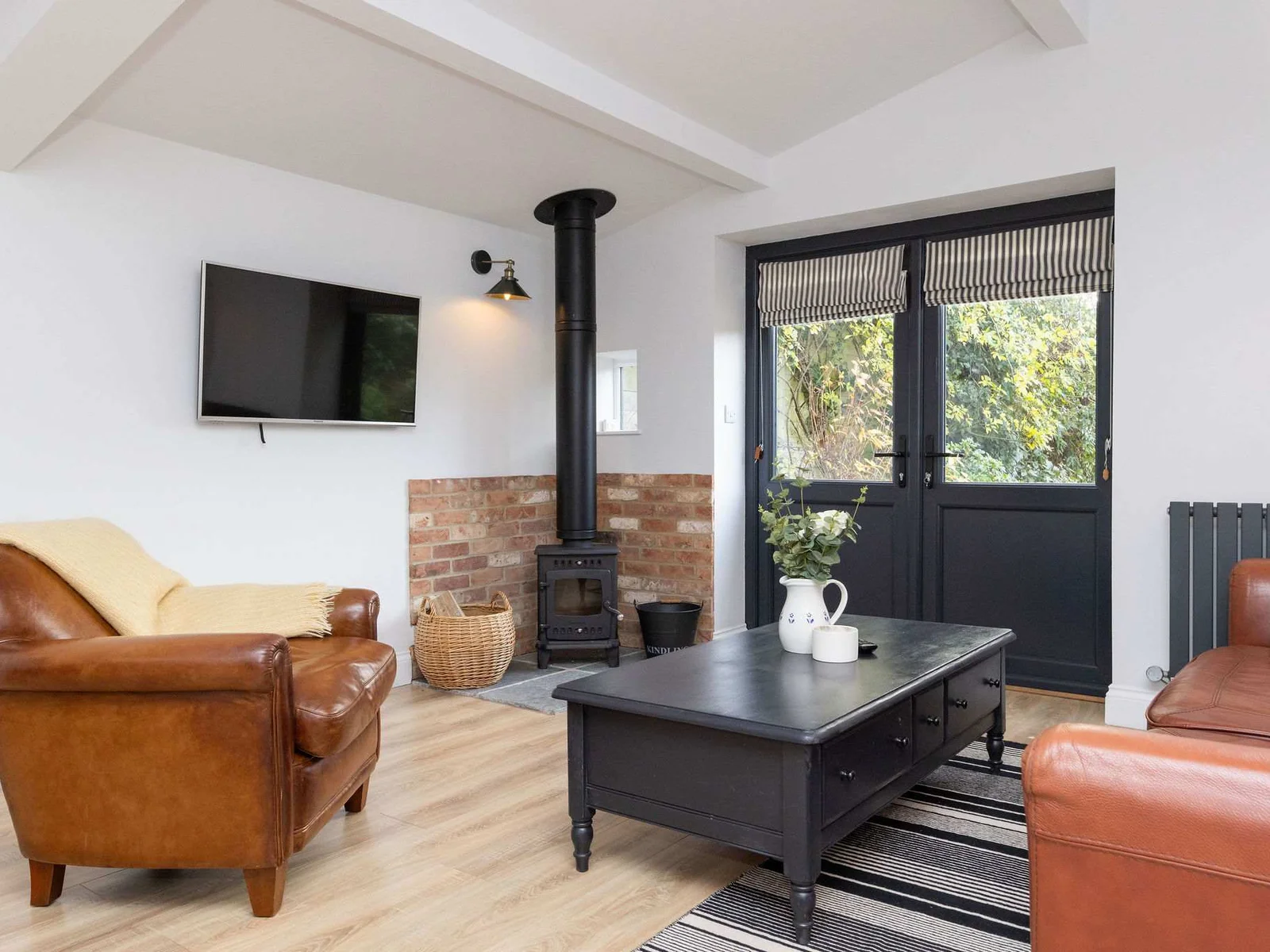 The living room has a smart TV and wood burner to enjoy!
