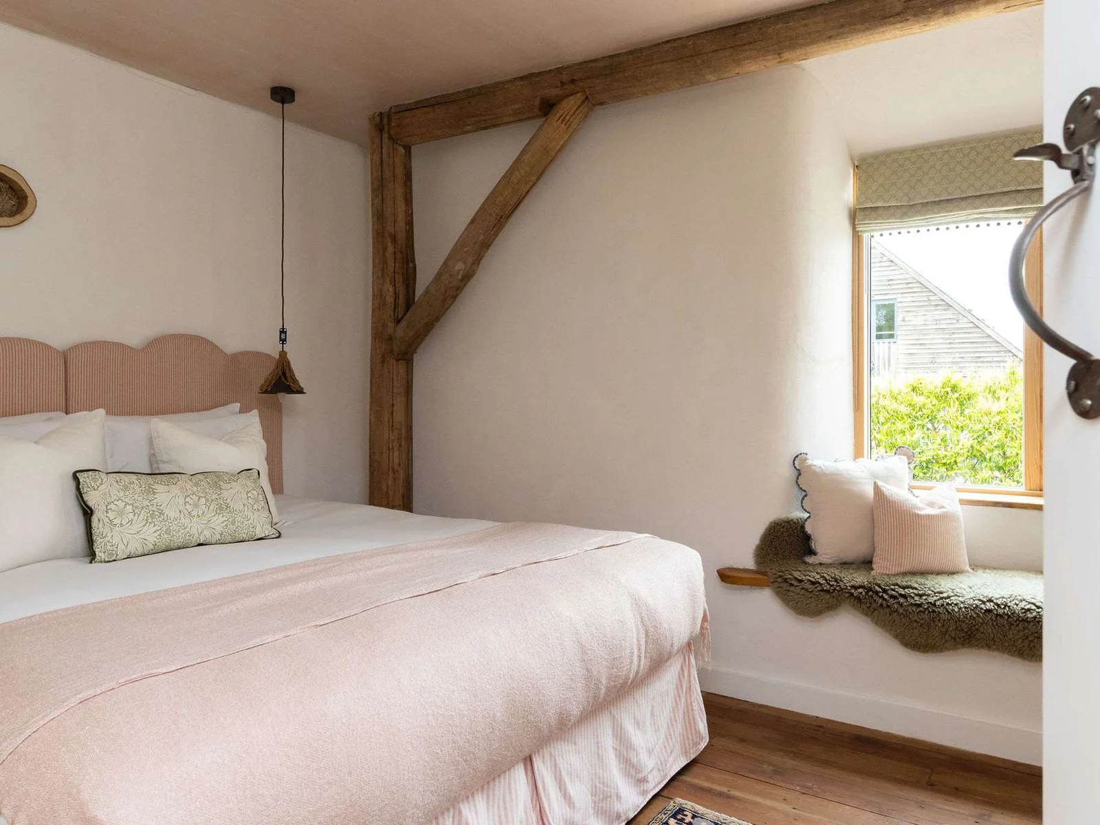 Wake up refreshed in a serene super king bedroom with charming countryside window views.