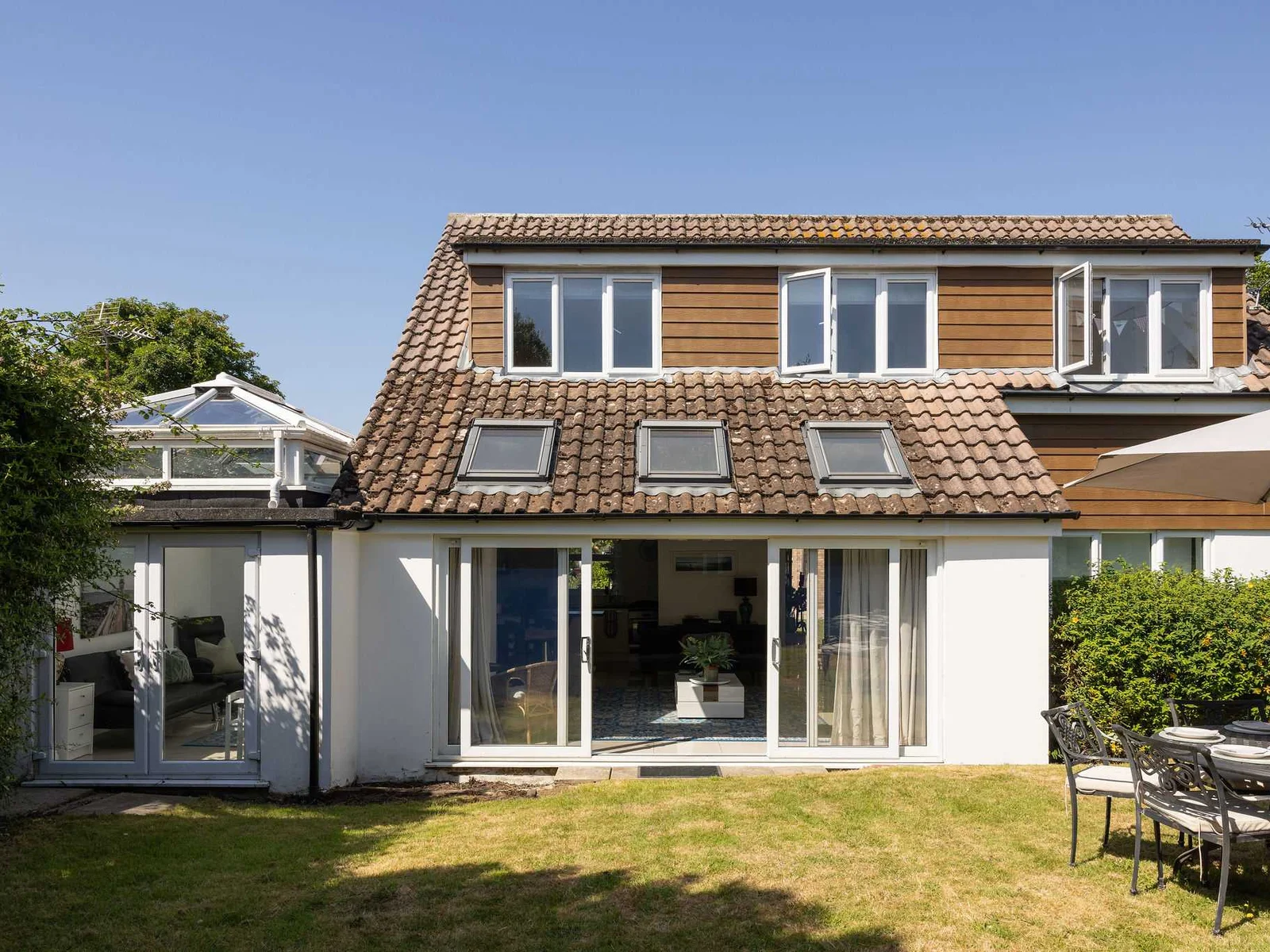Admire the beautiful exterior of this spacious holiday home featuring a lovely private lawn.