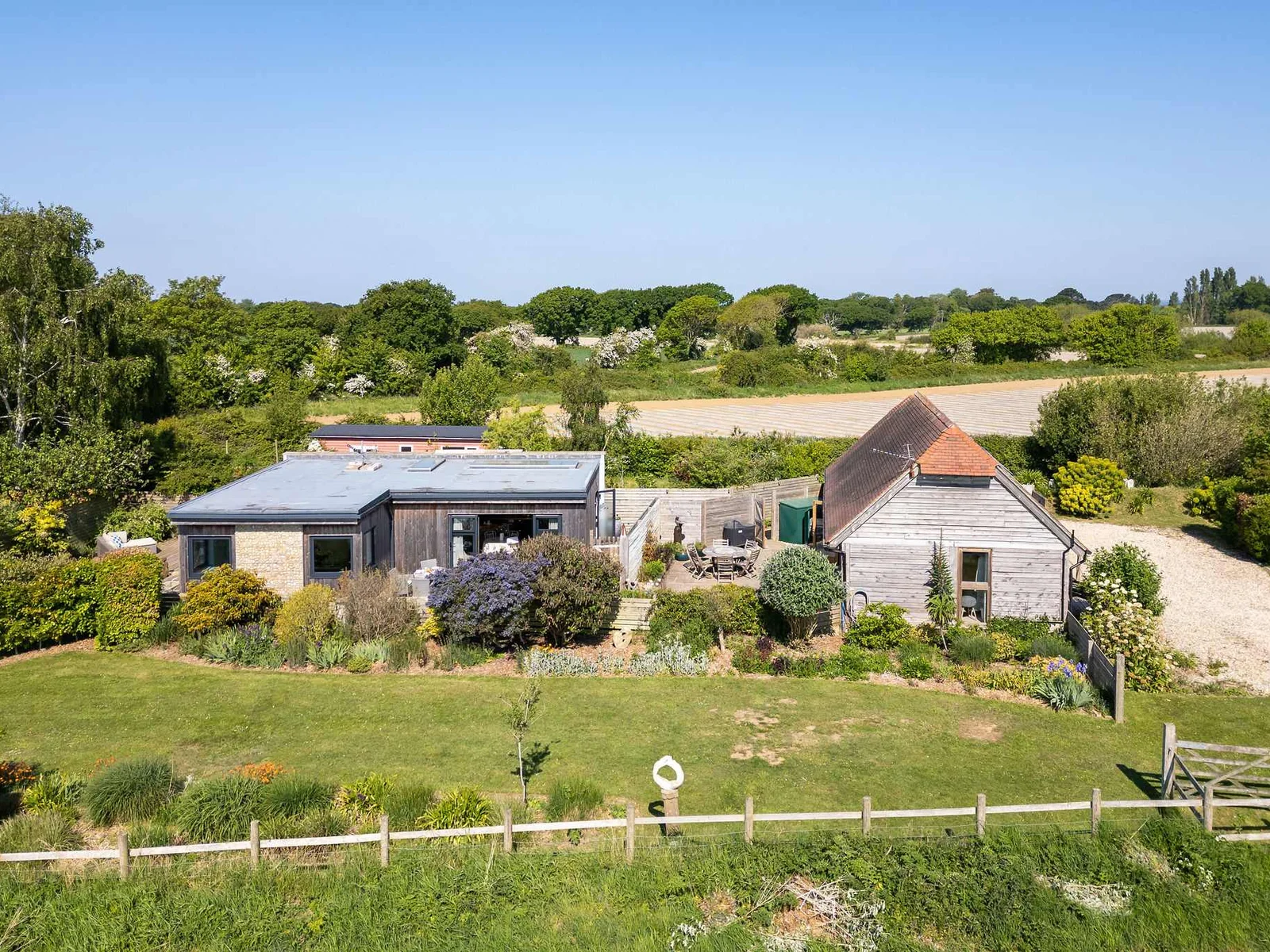 Peaceful rural setting, surrounded by expansive gardens and farmland views.