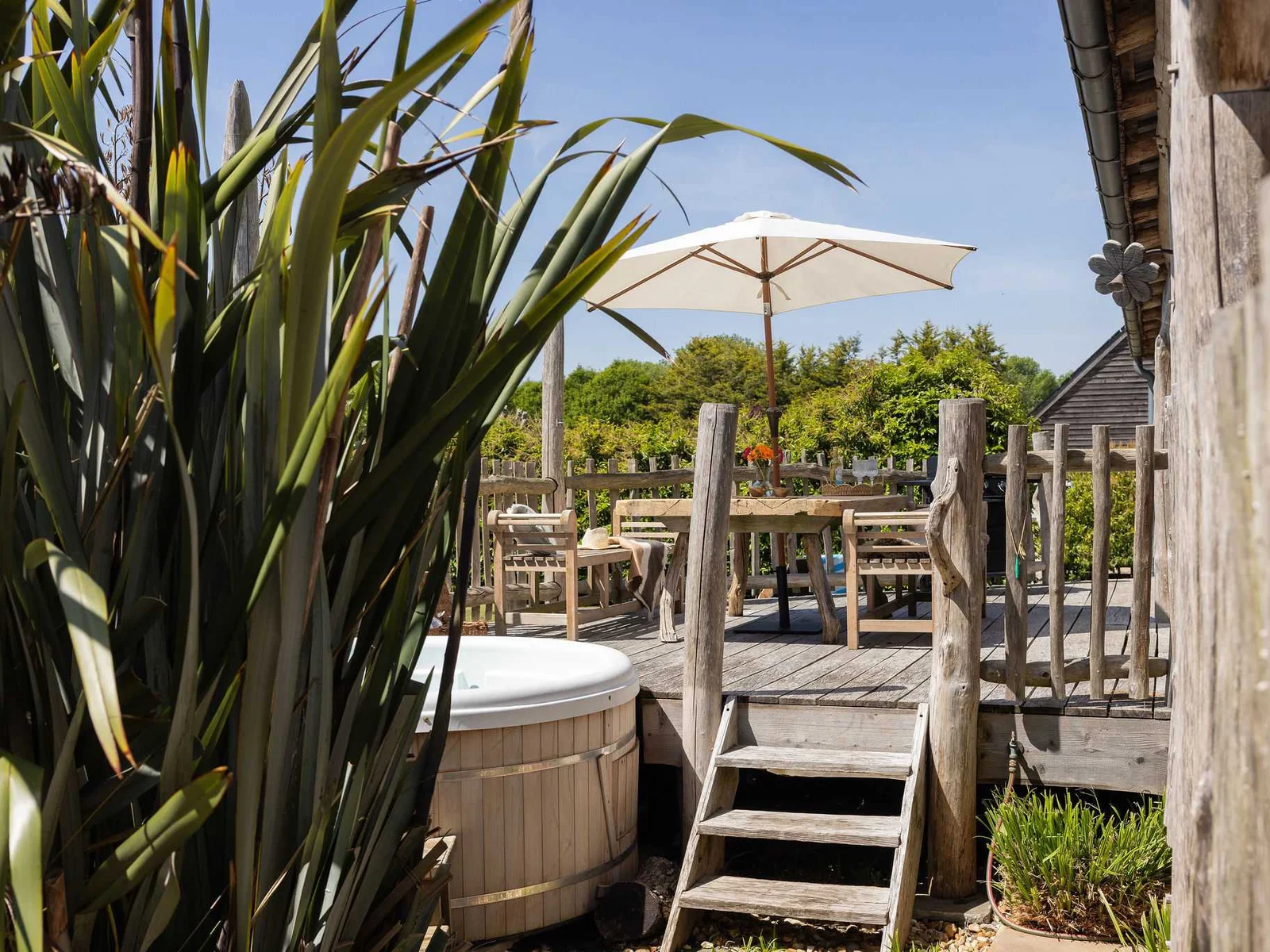 Hot tub, deck and countryside greenery — the ultimate spot to unwind and escape.