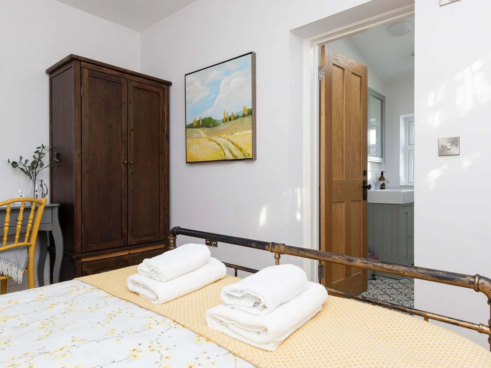 Ample storage with a wardrobe and desk, perfect for a relaxing seaside getaway. Enjoy the convenience of an en-suite bathroom just through the doorway.
