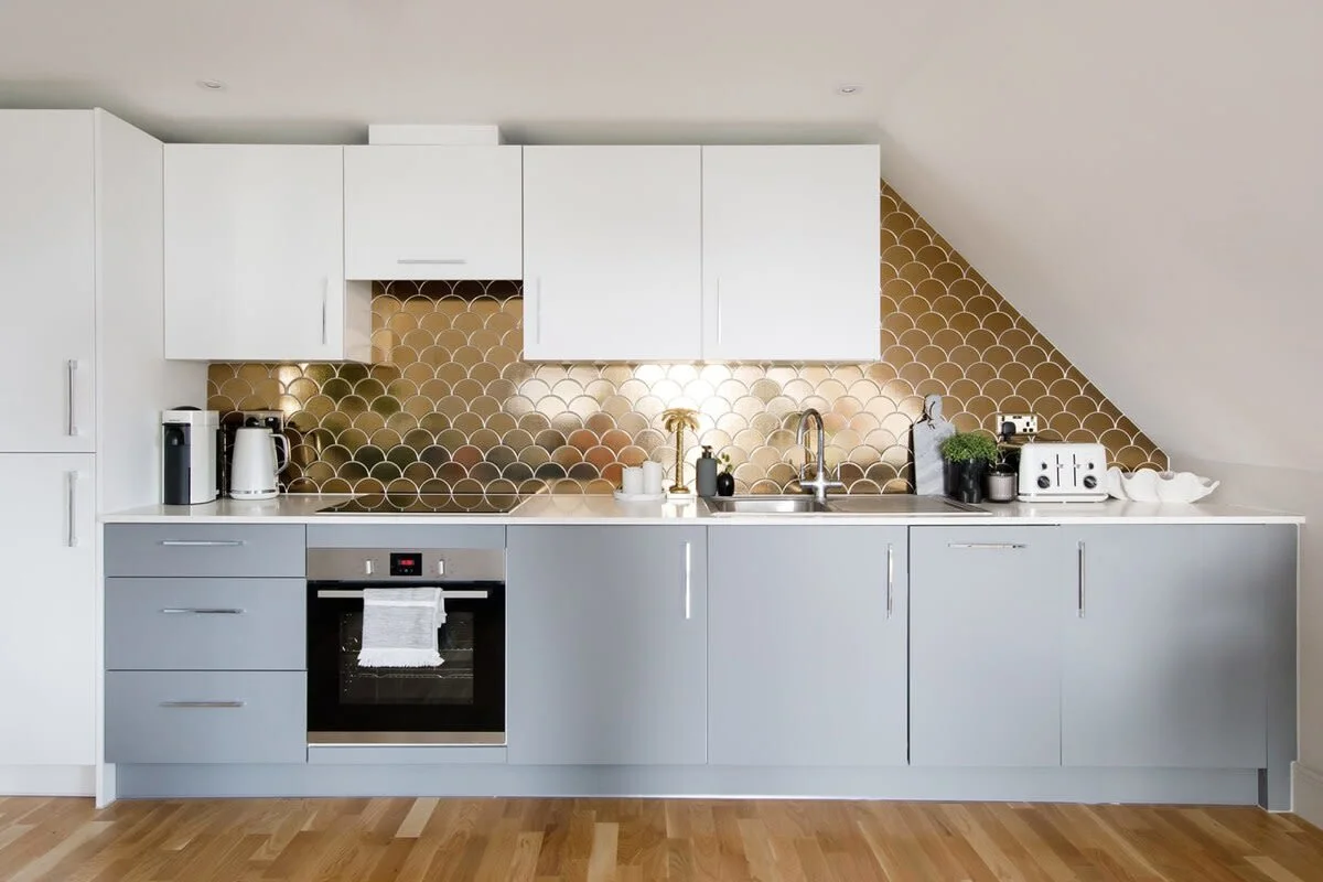 The north wall of the penthouse is covered with a contemporary, fully equipped kitchen.
