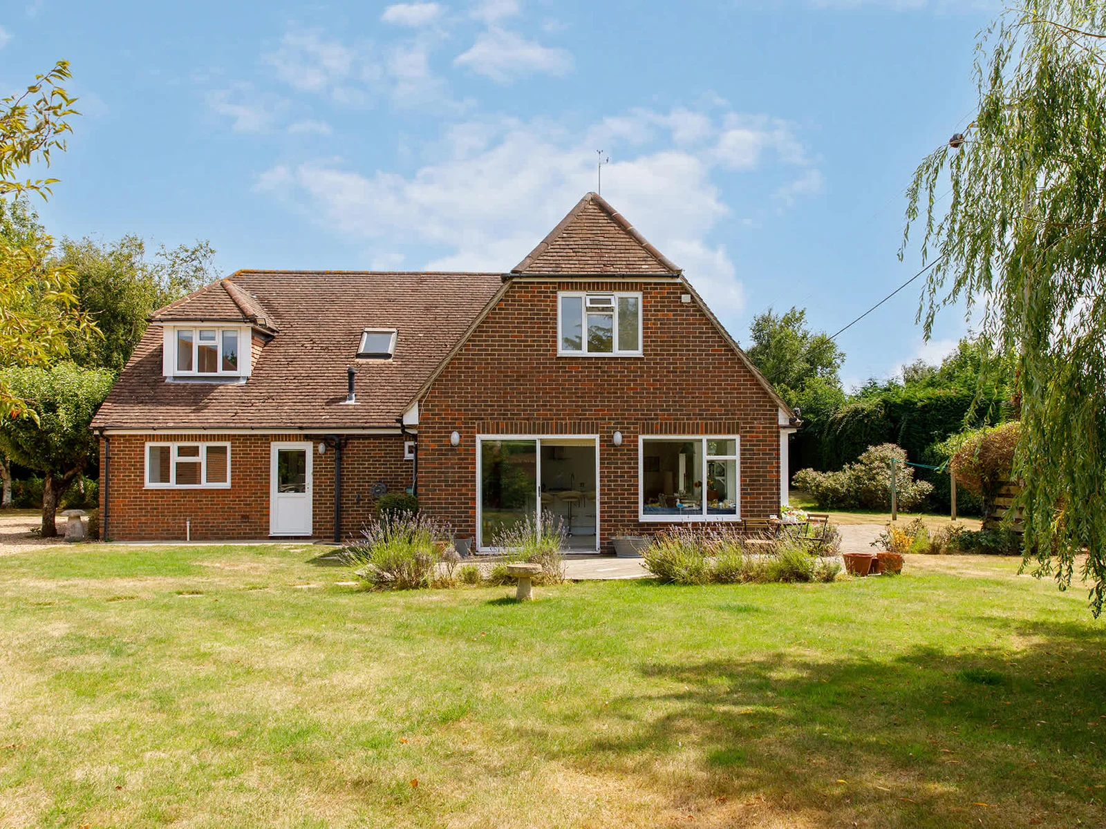 The garden is just under one acre and is surrounded by trees and shrubs.