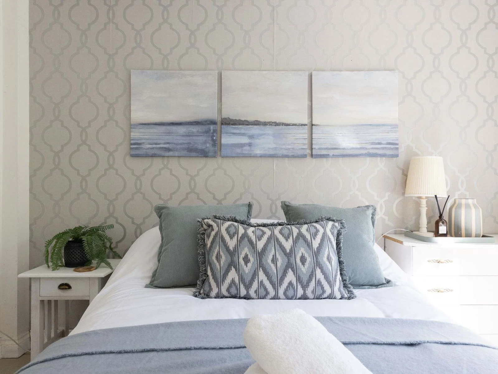 Admire the soothing seaside artwork from the comfortable bed of this beautiful coastal retreat.