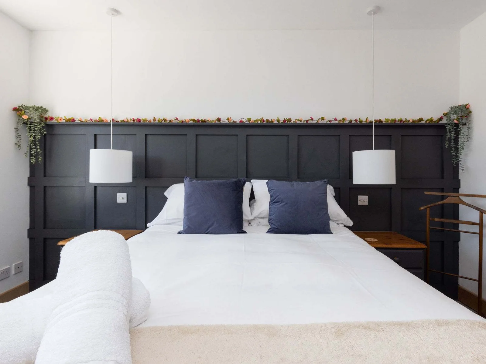 Bright king bedroom with plush bedding and storage