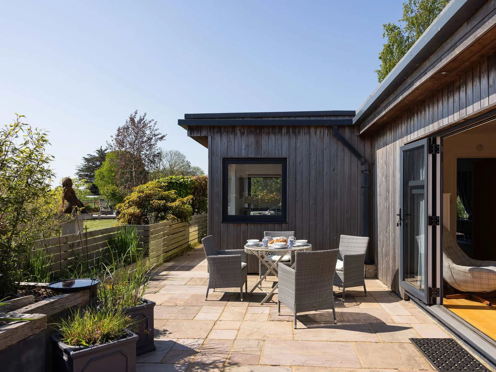 A serene outdoor space, complete with furnishings, perfect for enjoying a meal or simply unwinding.