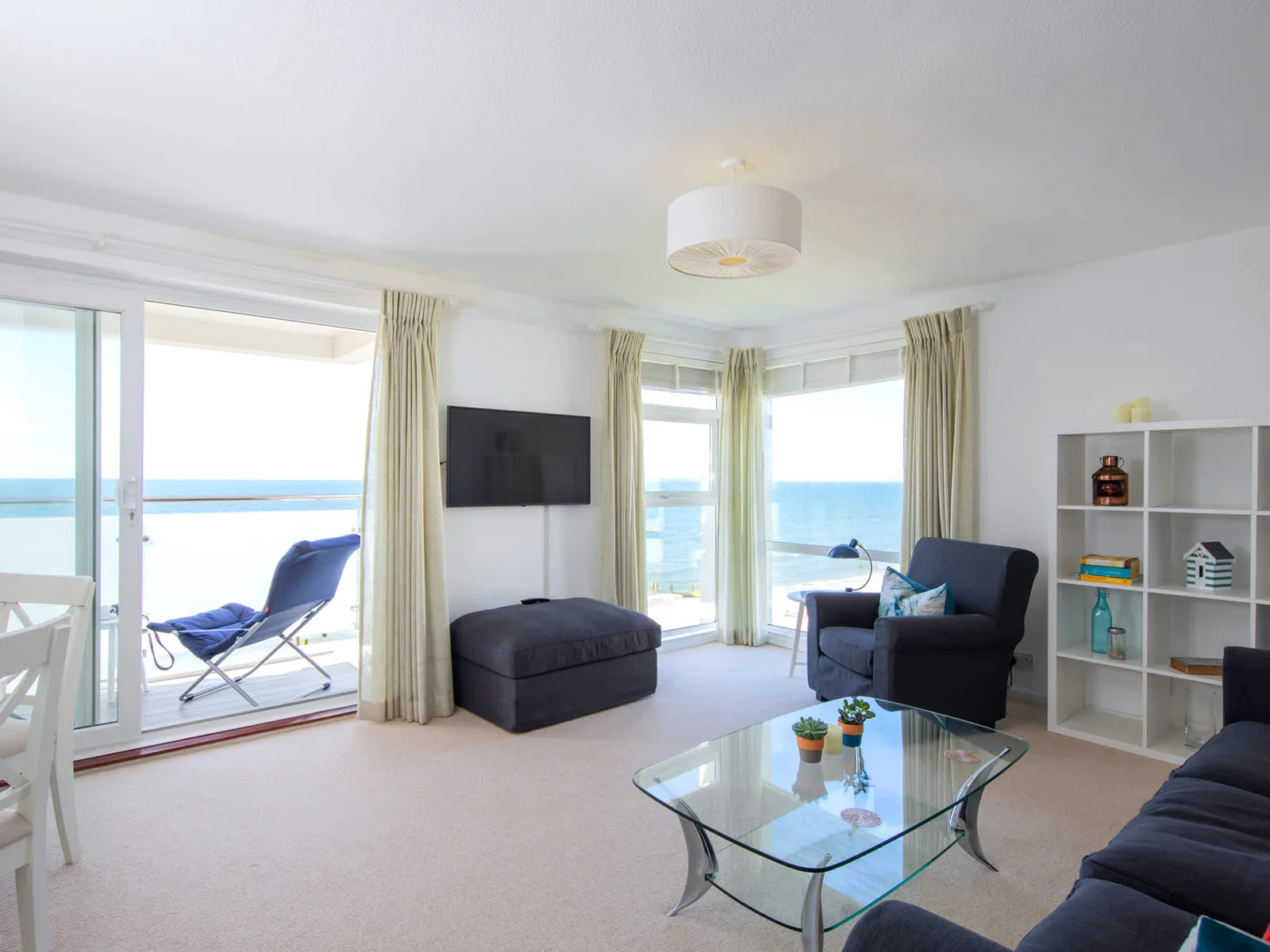 Find your place on the comfy sofa, sofa chair, and ottoman, and enjoy the panoramic sea views!