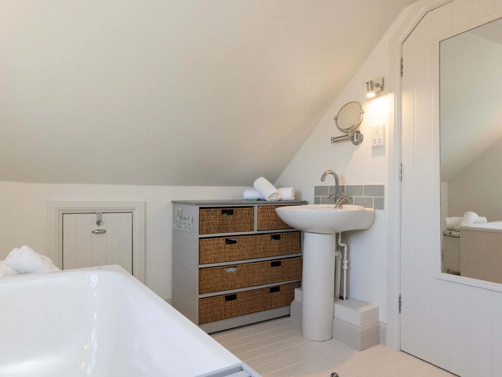Bright and airy bathroom with thoughtful storage and soft coastal styling