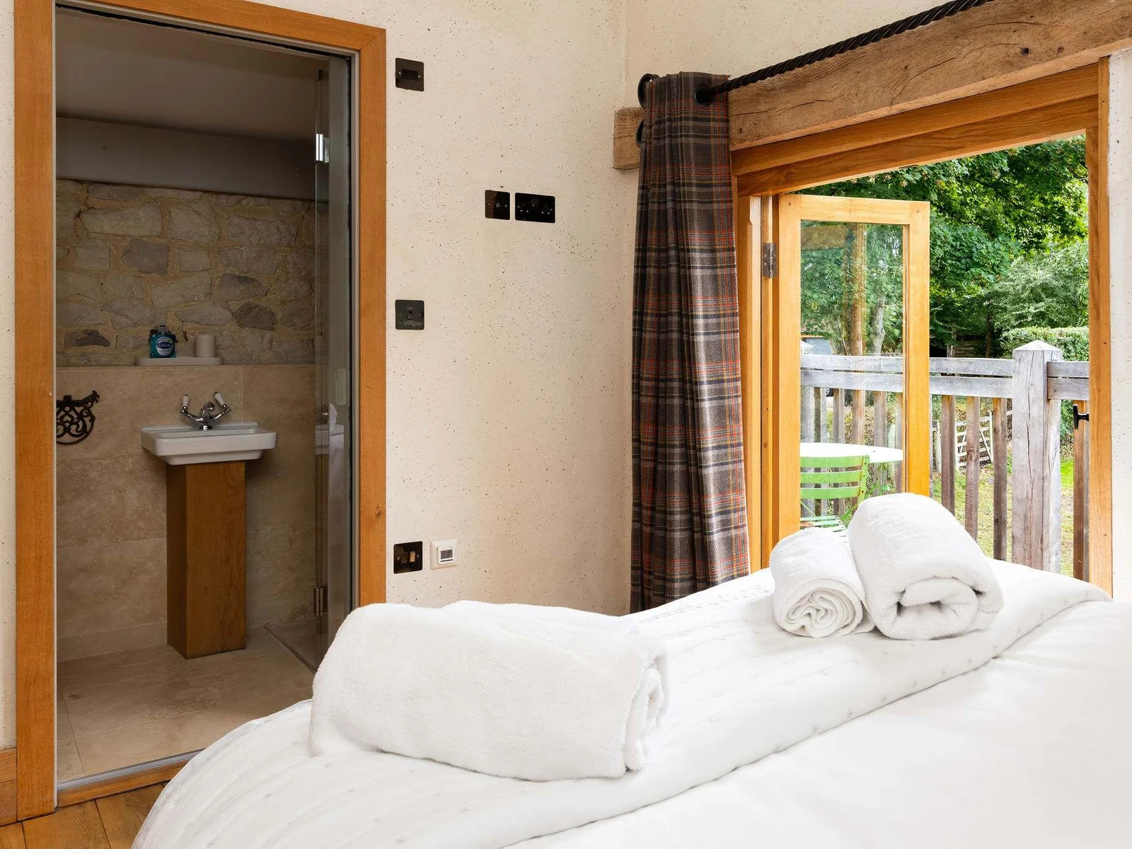 A bright character bedroom opens directly onto its own outdoor seating area.
