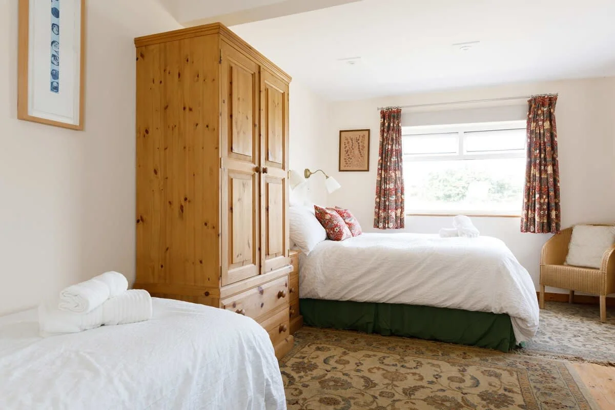 This room has a small double bed and single bed.