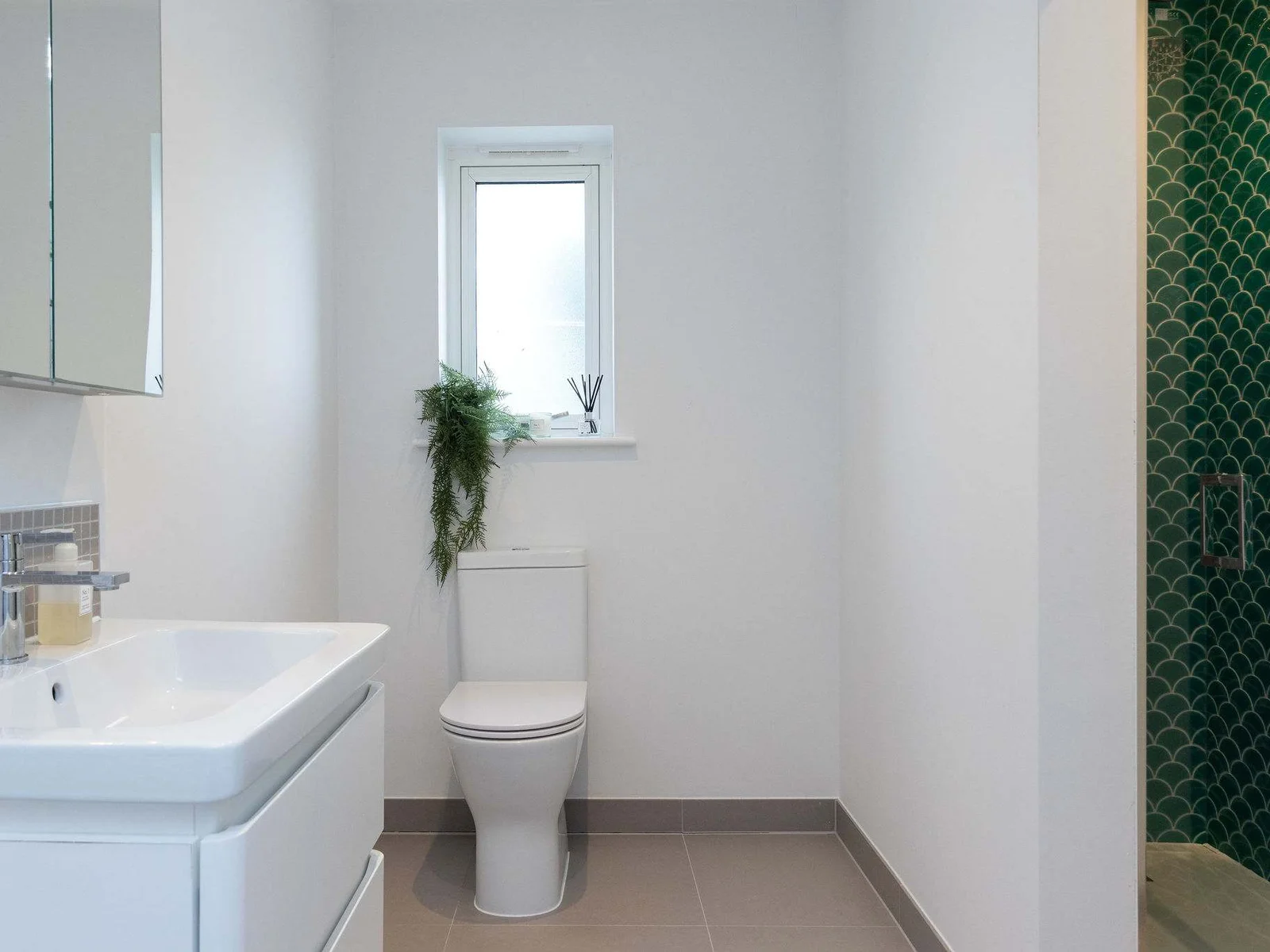 A sleek shower room with a bold splash of colour