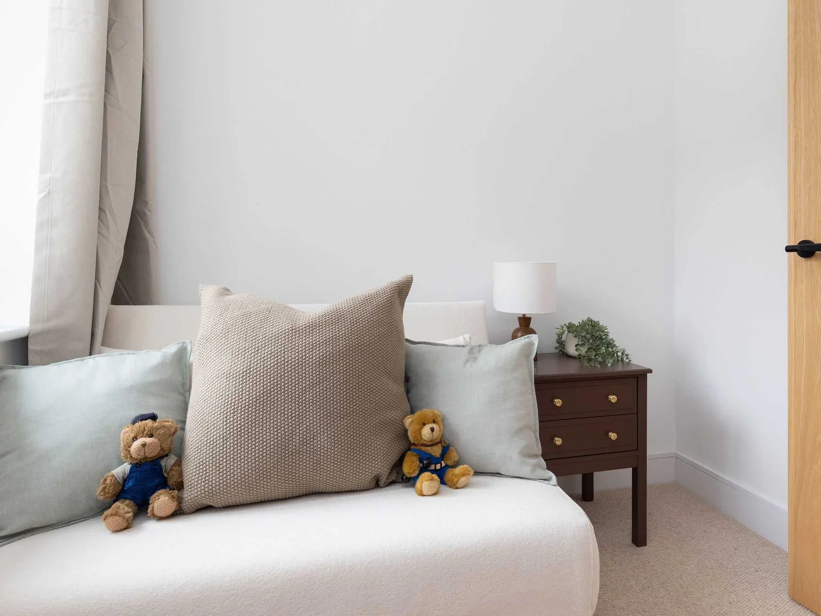 Comfortable seating nook with soft furnishings and window views