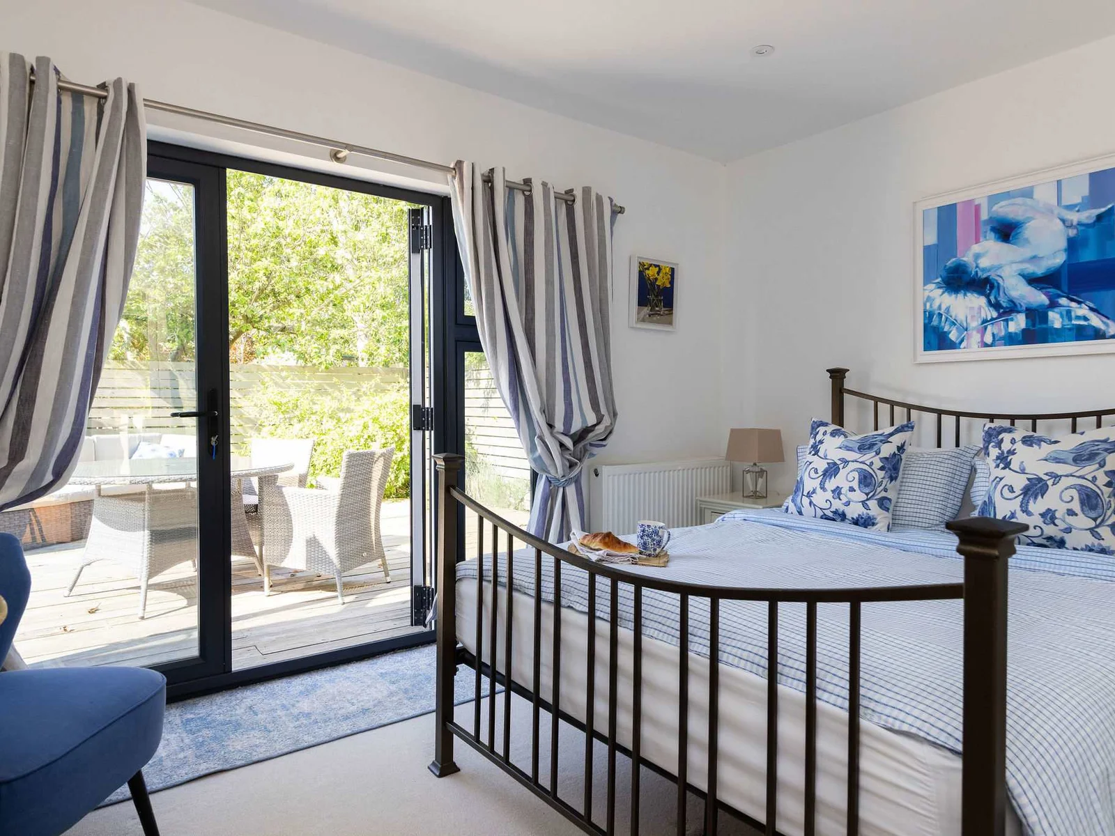 The master bedroom offers a comfortable king-size bed and direct access to your private patio.