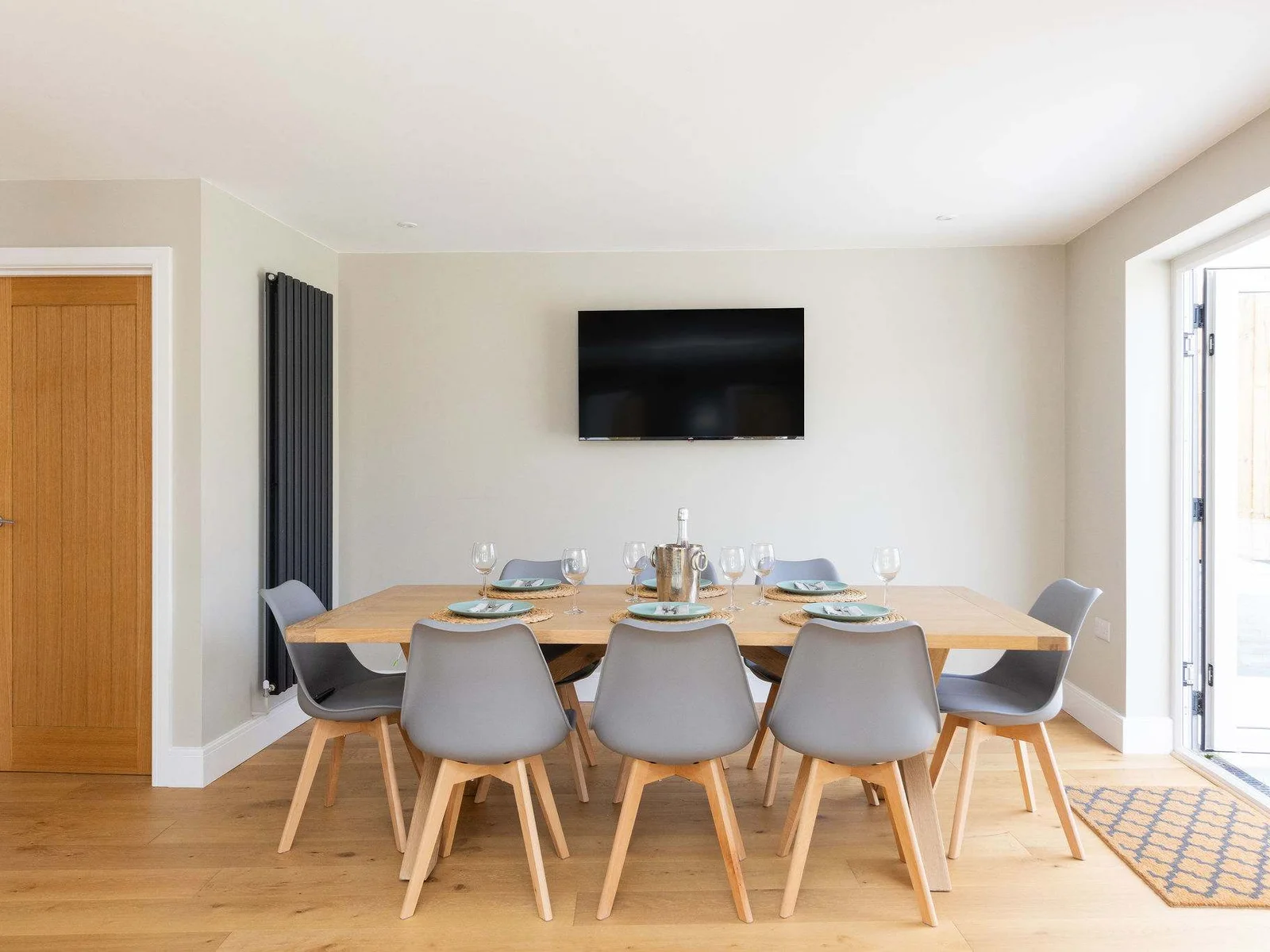 A modern dining space with a TV for casual, relaxed meals.