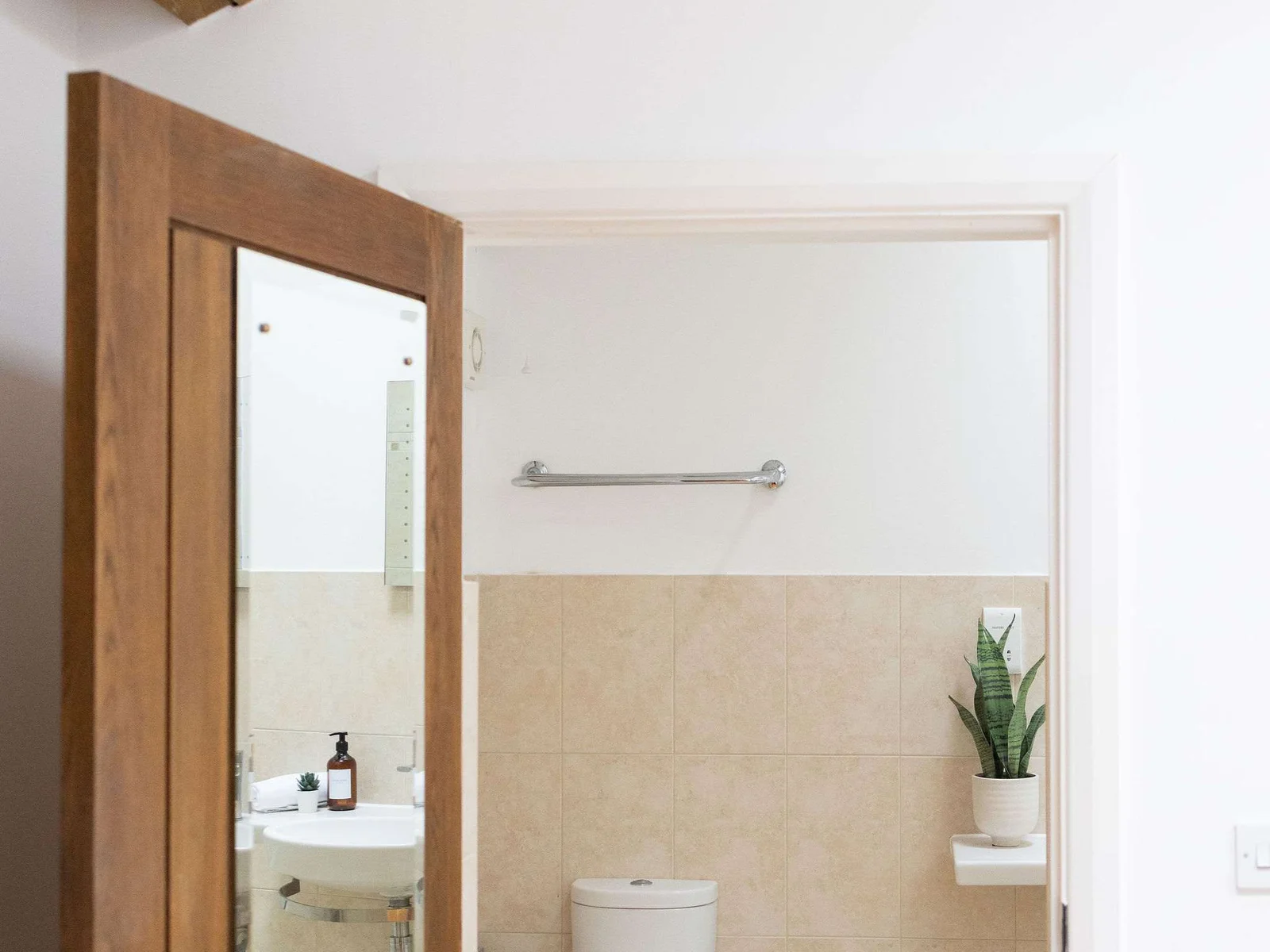 A mirrored door connects the room to the ensuite.