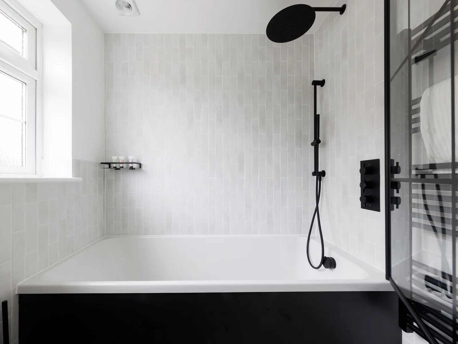 Contemporary bathtub with black fixtures and a minimalist design for a spa-like experience