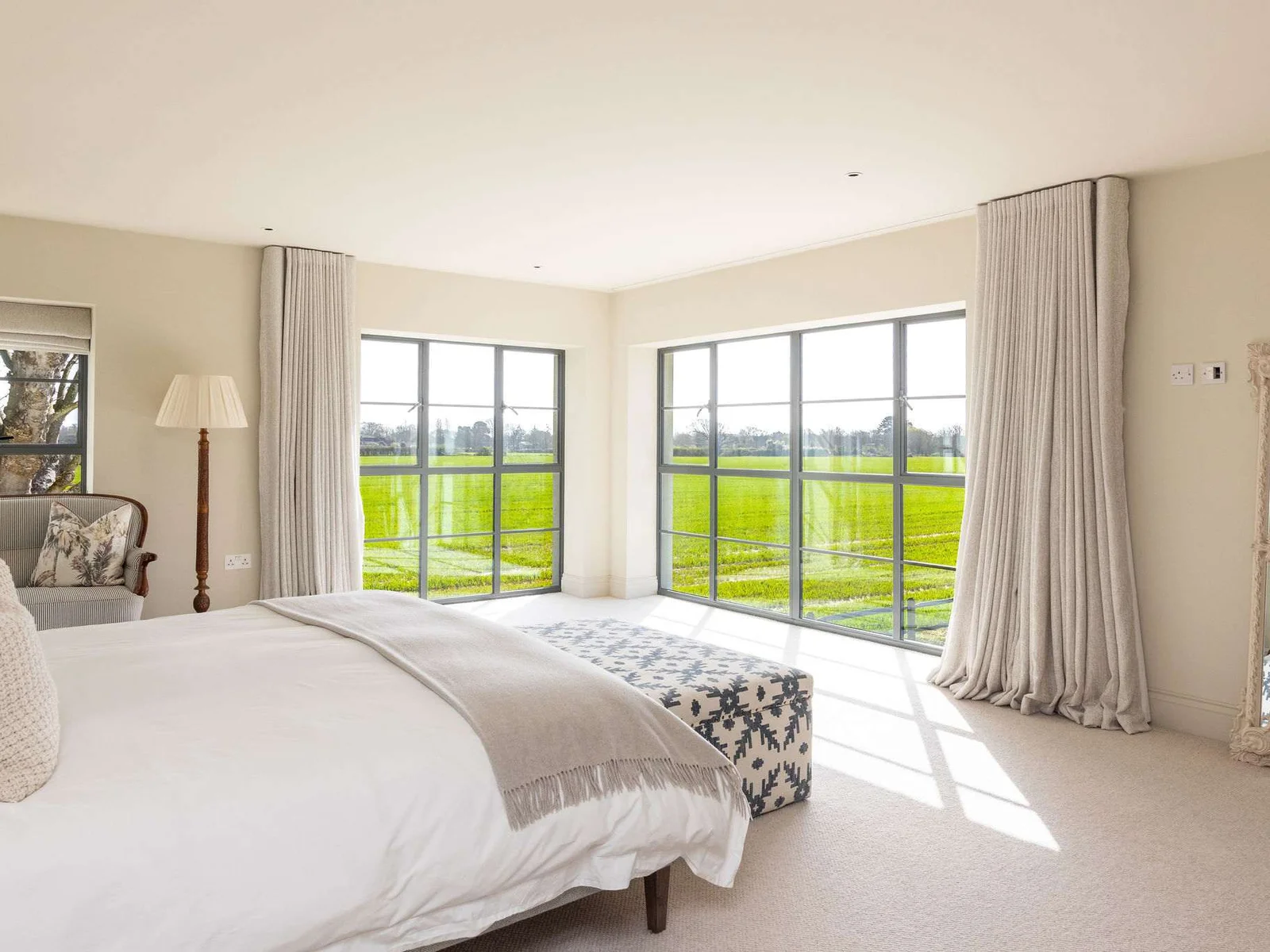 Luxurious master suite with panoramic countryside views, high-quality linens, and a private ensuite.