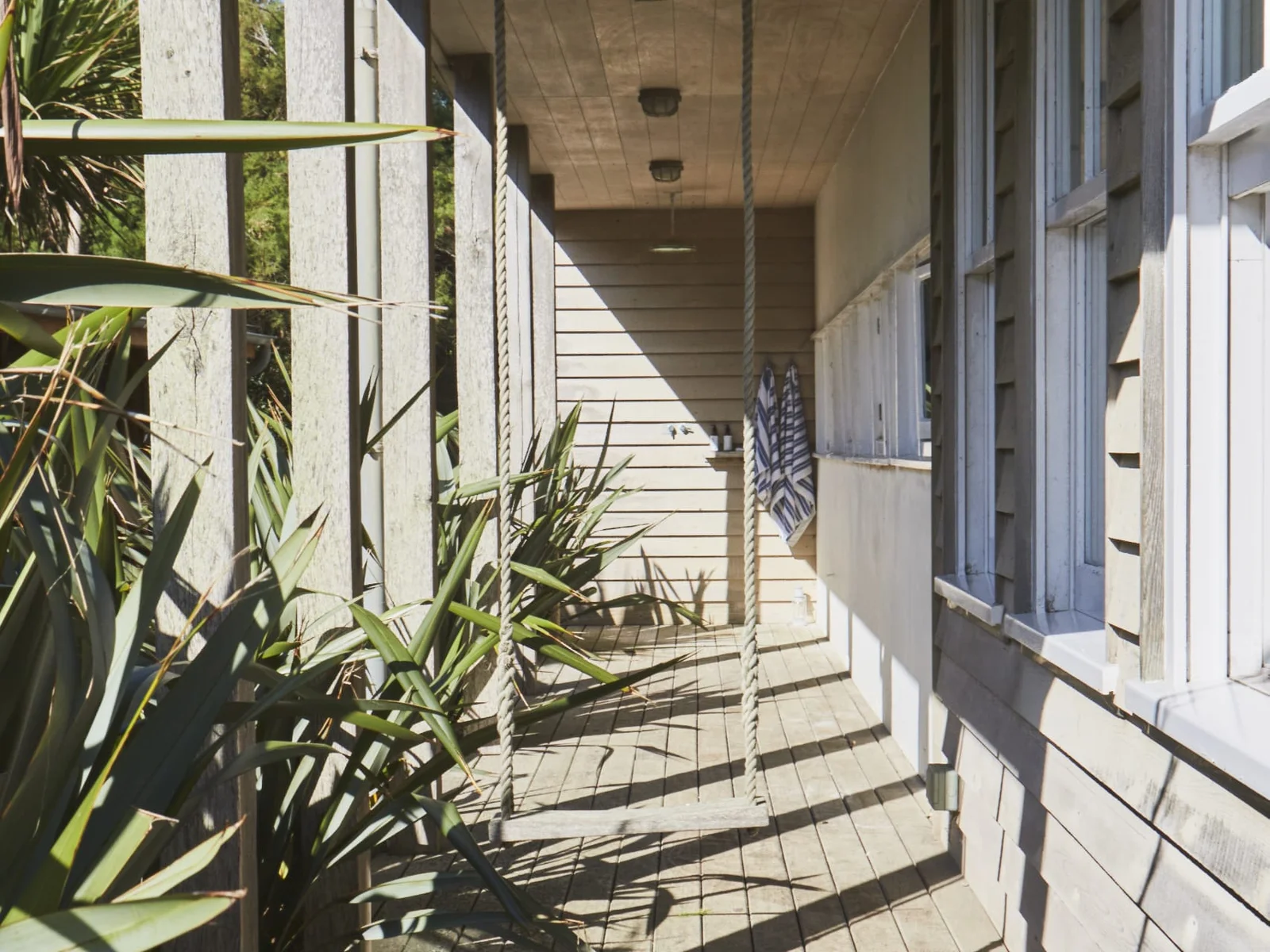 The outside of the home is beautifully decked, offering numerous places to sit, including a porch swing.