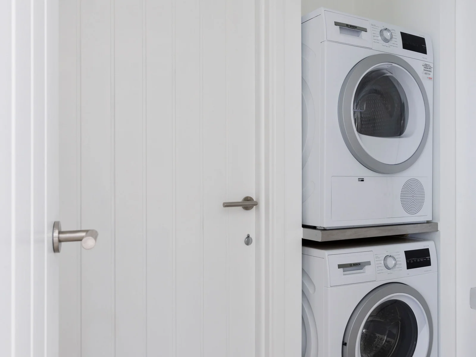Compact laundry area with a stacked washer and dryer for convenience