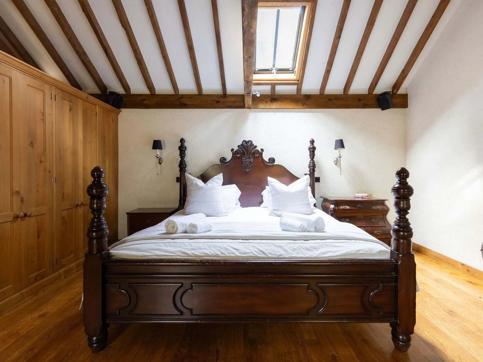 A striking character master bedroom with a statement super king bed, vaulted beams and plenty of natural light.
