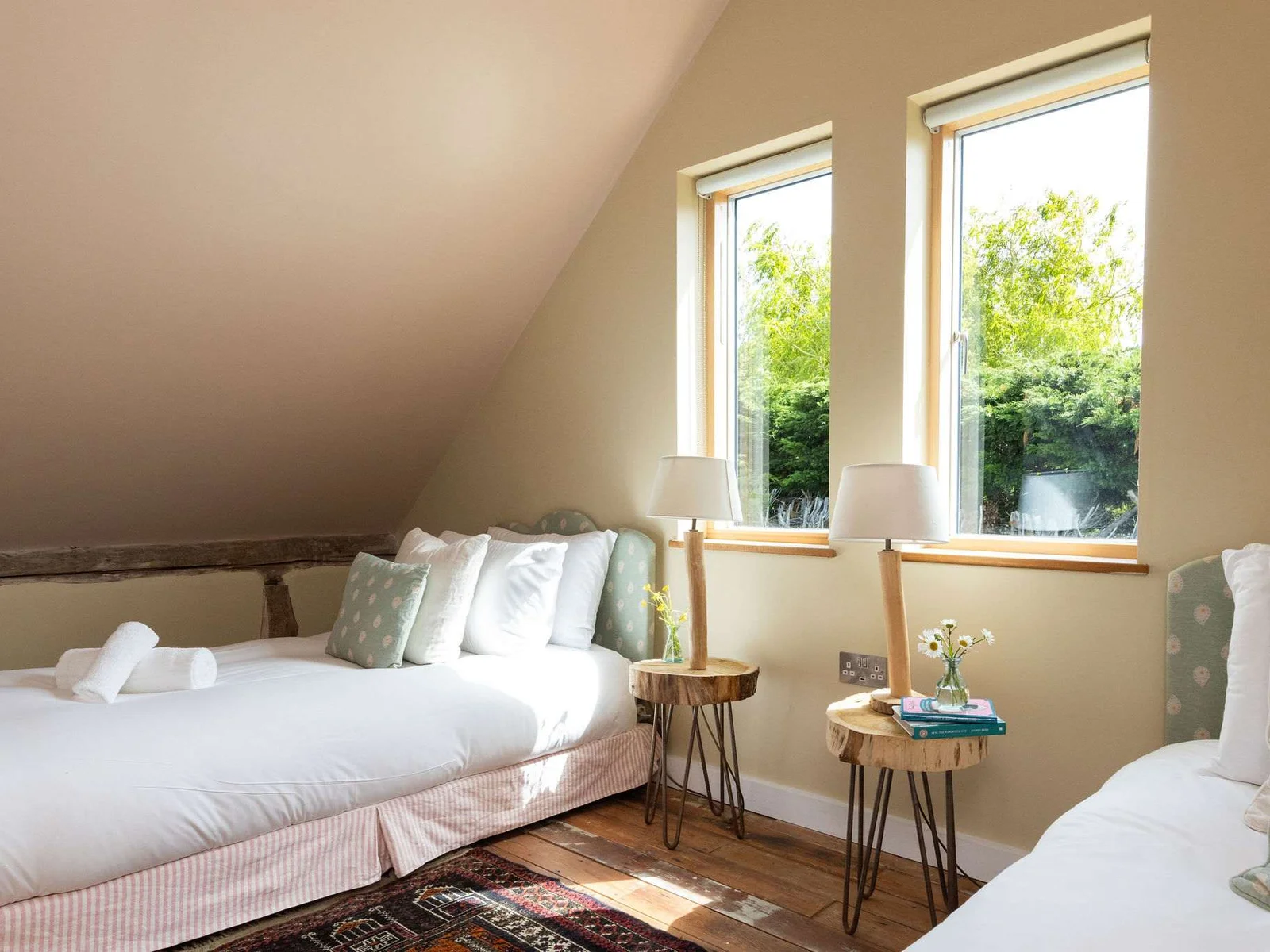 Light-filled twin beds with garden views — a relaxed and welcoming space for all.