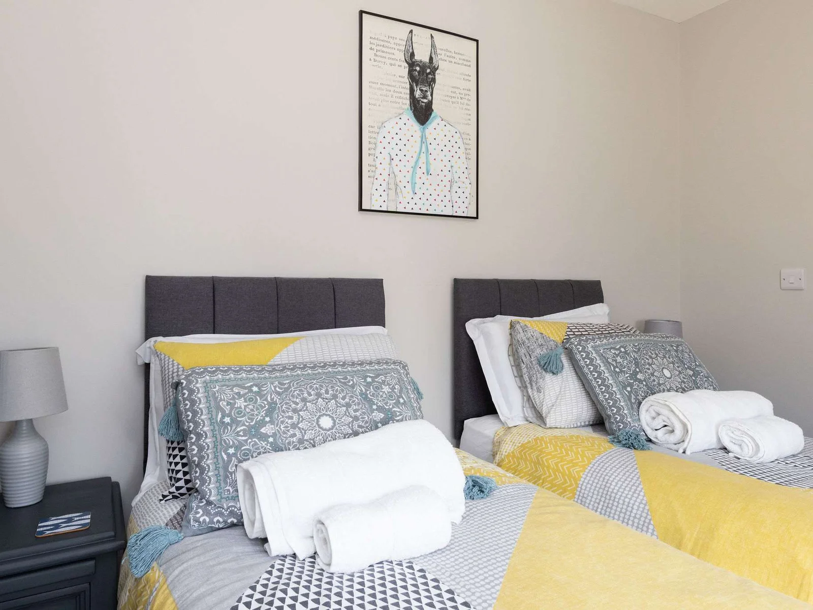 Comfortable twin bedroom with soft furnishings, ideal for families and friends enjoying coastal breaks