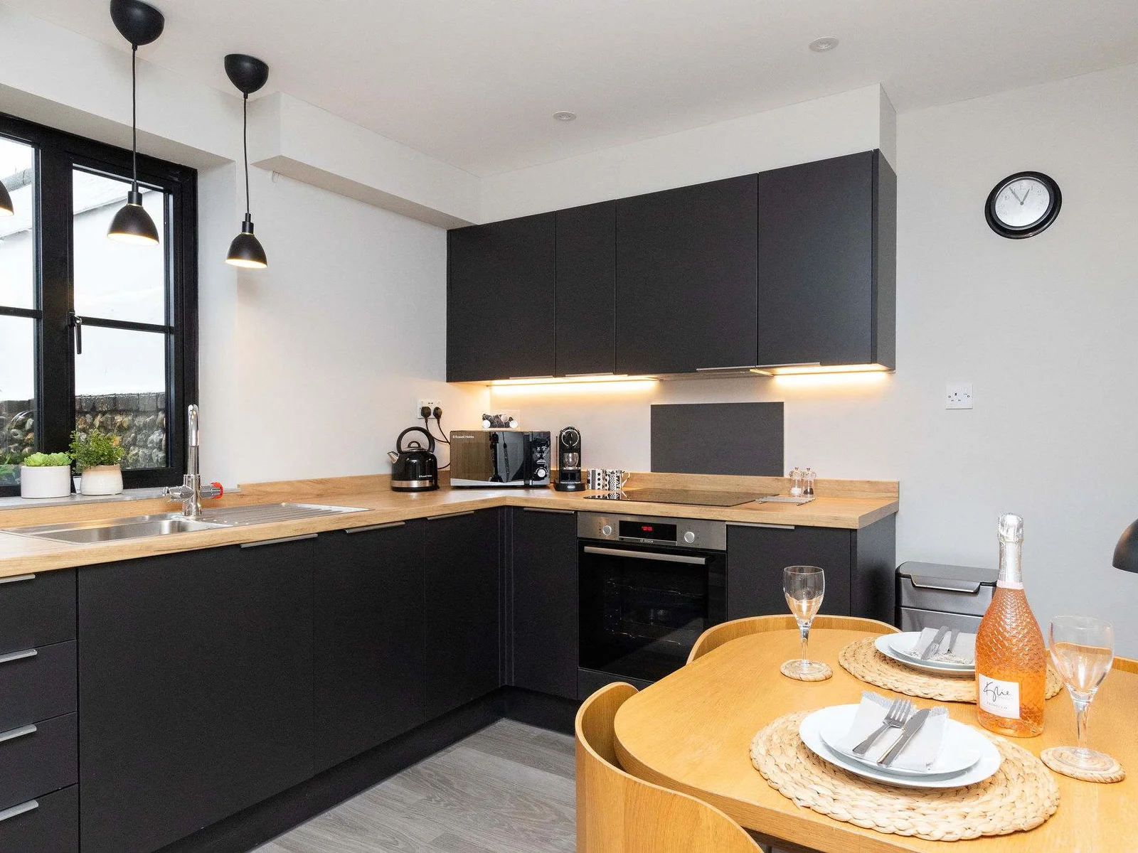 Dark cabinetry with wooden worktops, compliment each other perfectly.