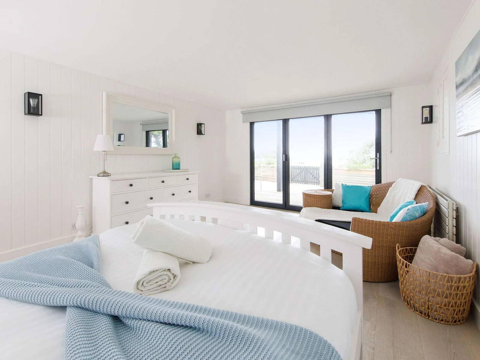 The bifold doors open up to the private garden with access to the beach.