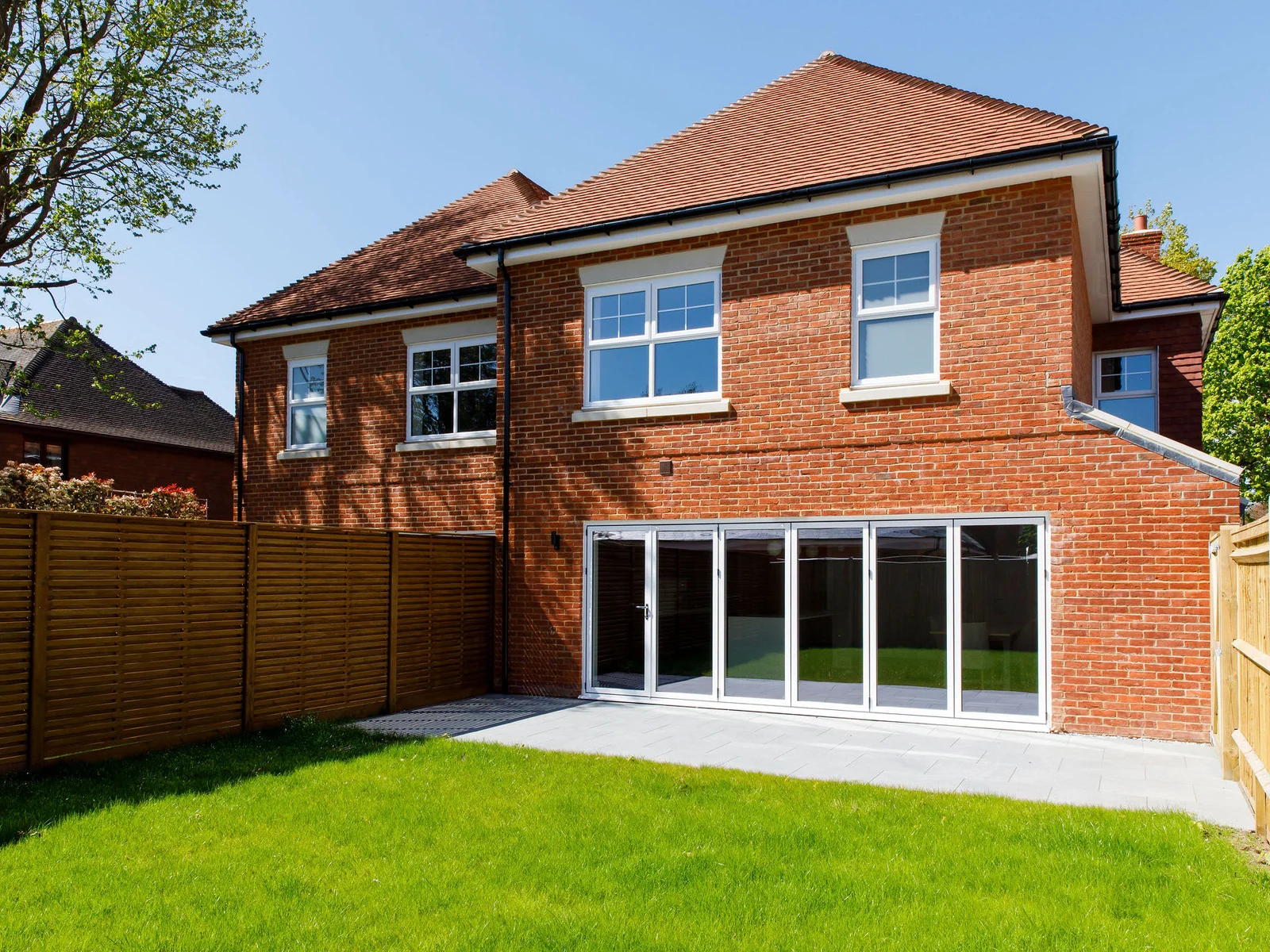 The open plan living space leads out onto a beautifully lawned garden.