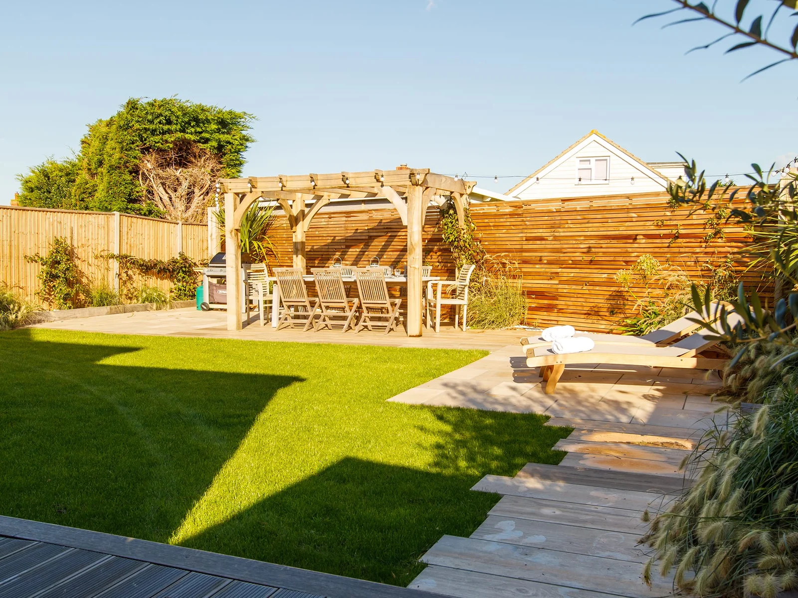 The garden is a great space combining lawn, decking and seating.