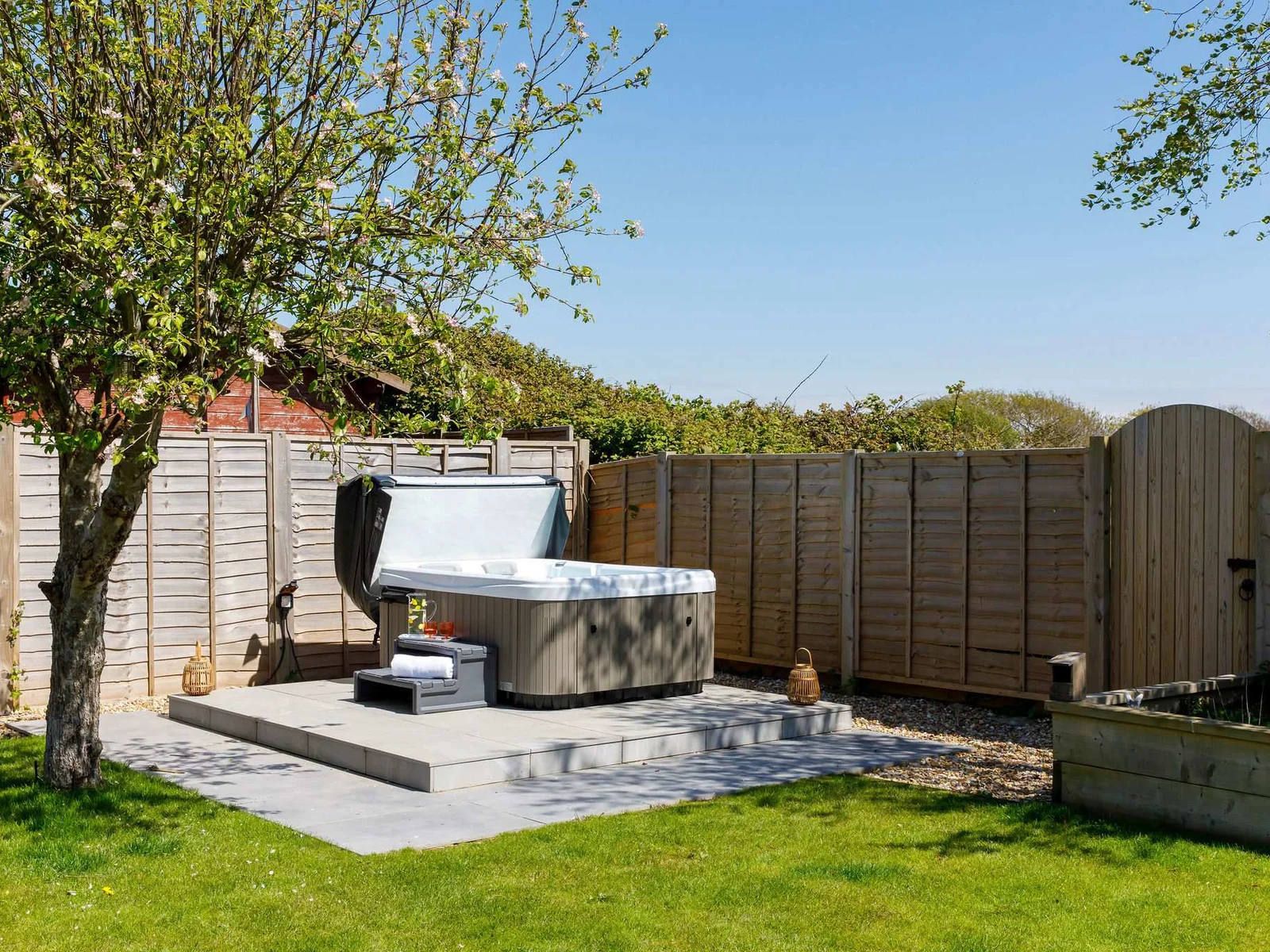Enjoy a soak in the private hot tub, surrounded by a peaceful and beautifully maintained garden.
