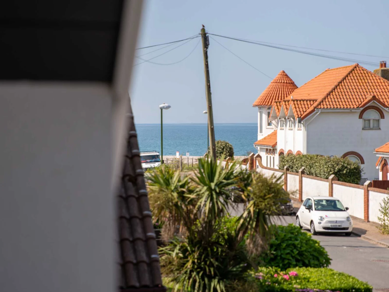 The home's prime location puts you just a couple of steps away from the beach. You can gaze at the sea from the upstairs balcony