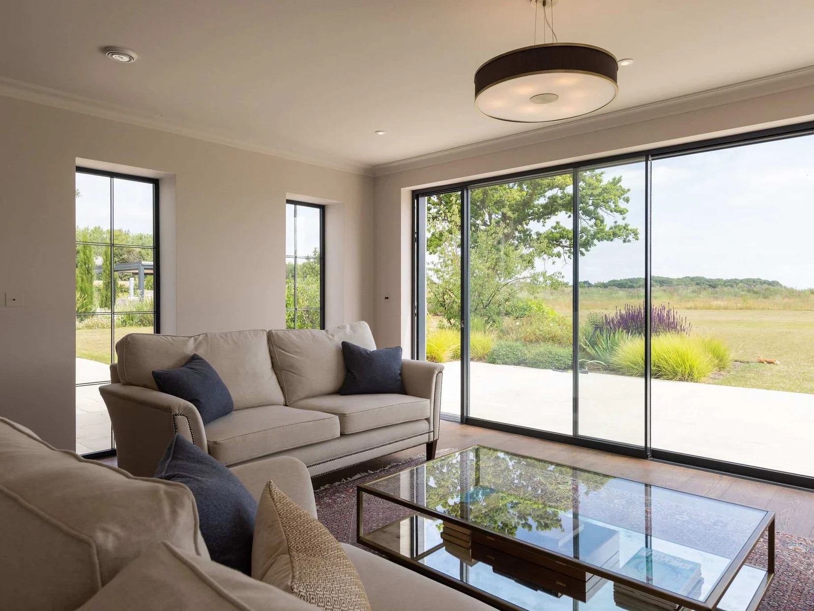 Large windows frame the peaceful countryside