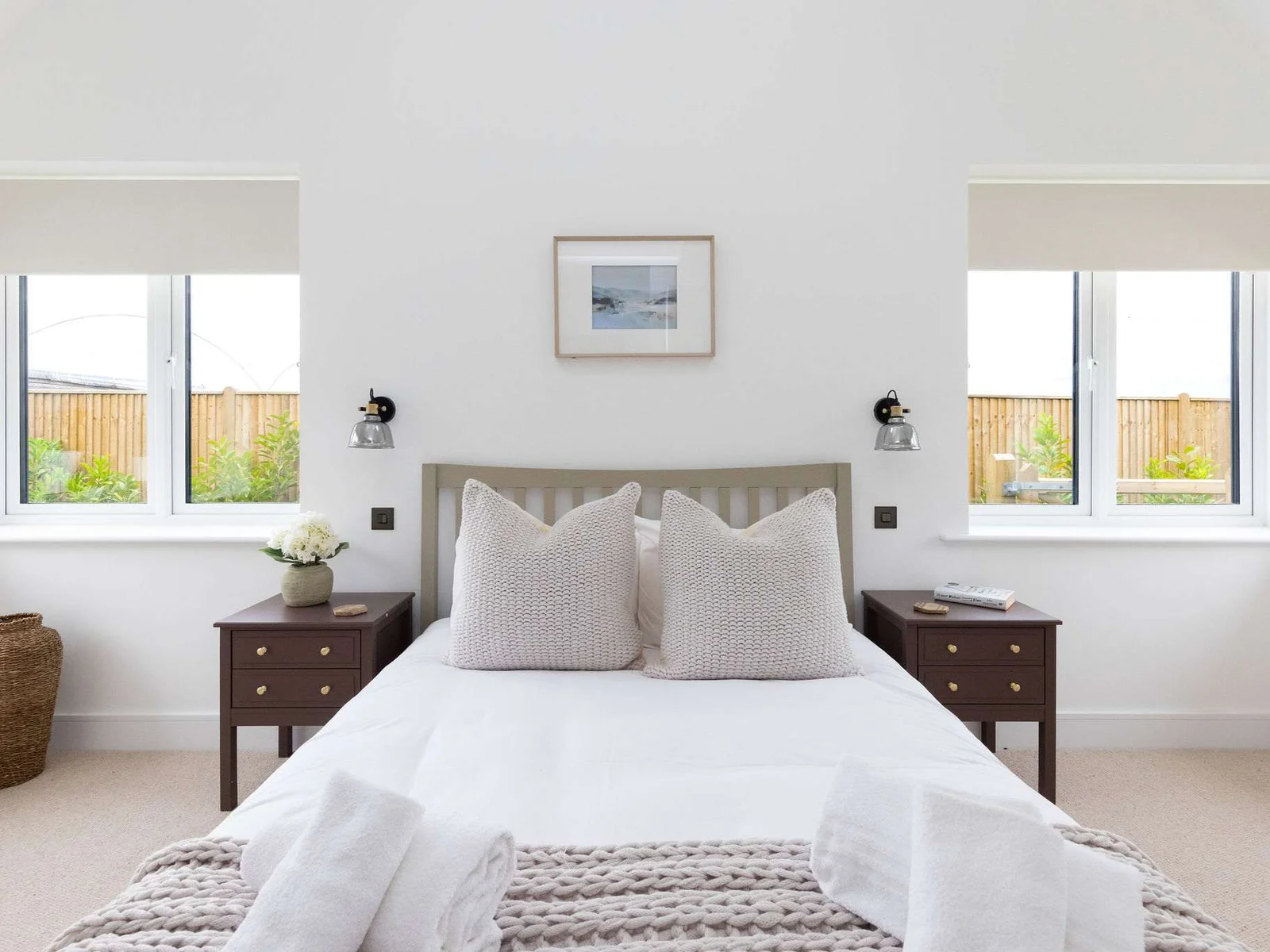 Spacious bedroom with twin windows and comfortable bedding