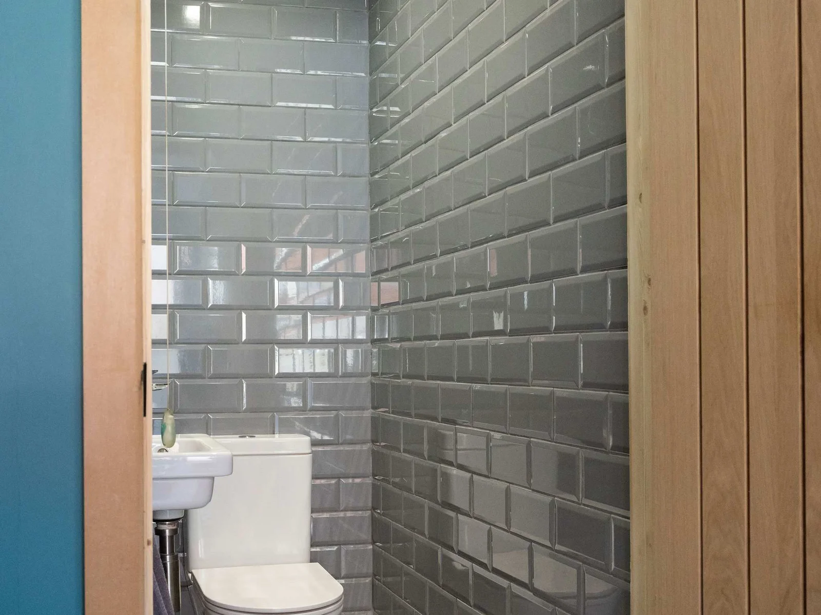 Stylish WC with glossy grey tiles
