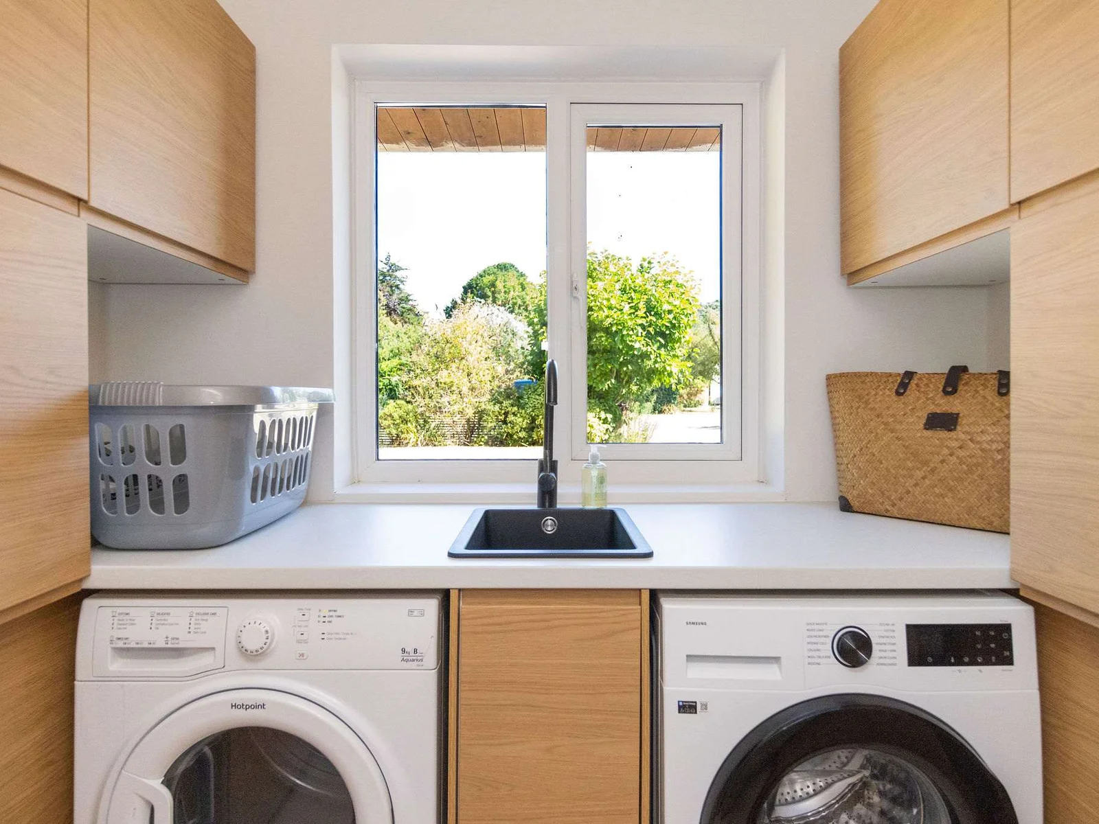 A well-equipped utility room with sink, washing machine, tumble dryer and plenty of cupboard storage — everything you need to make longer stays and family holidays feel effortless.