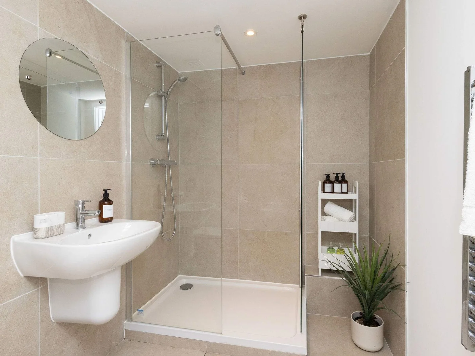Contemporary walk-in shower room with fresh towels for a comfortable and relaxing stay.
