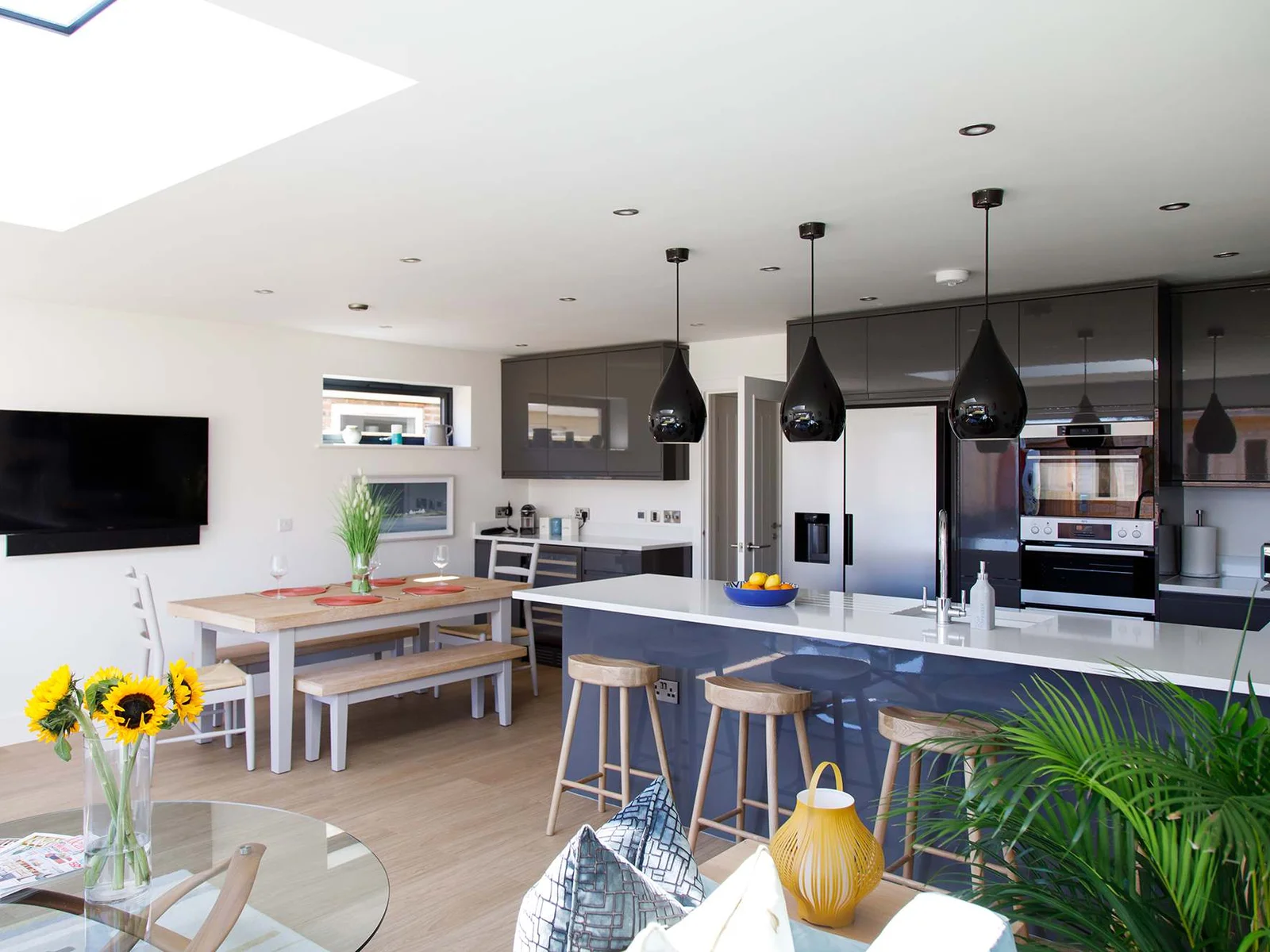 The open plan living and dining space is contemporary and modern in style.