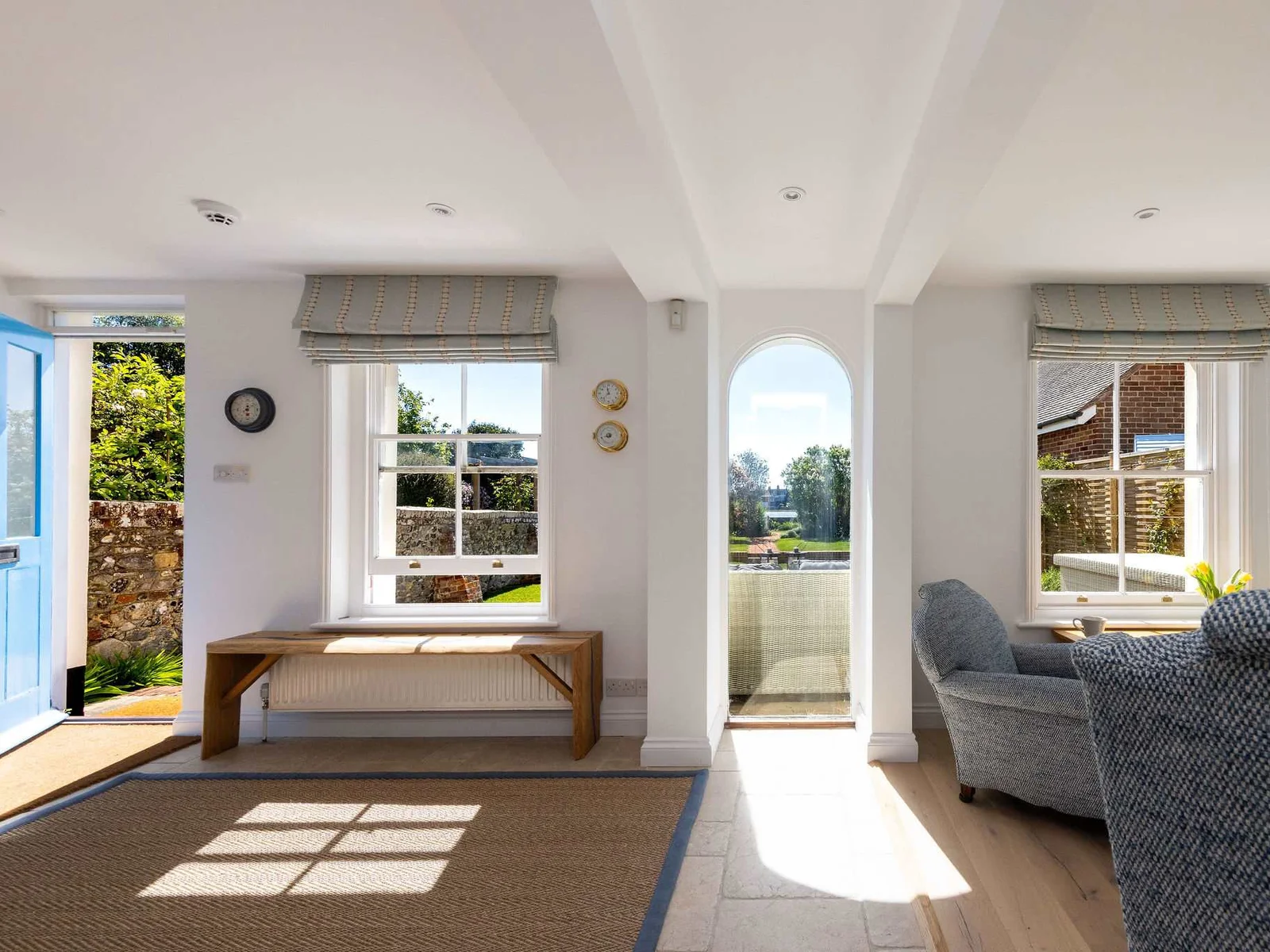 Bright entrance with garden and water views