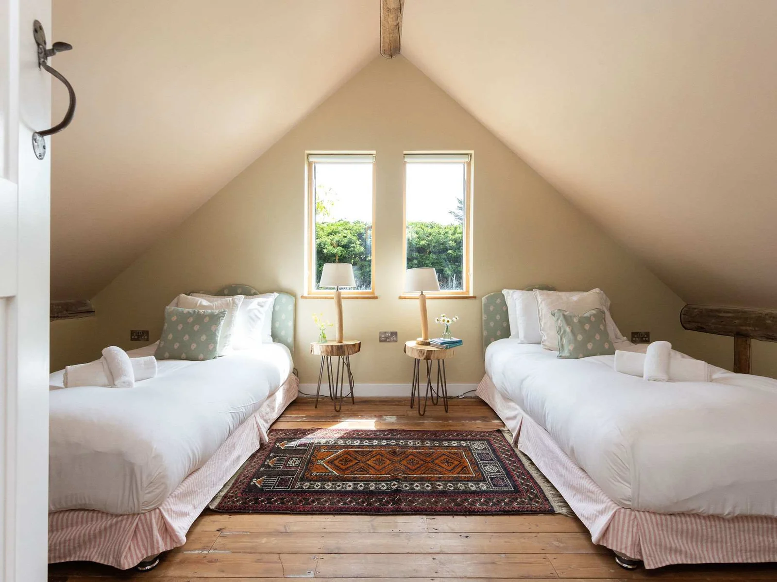 A charming twin bedroom bathed in natural light — perfect for families and groups.