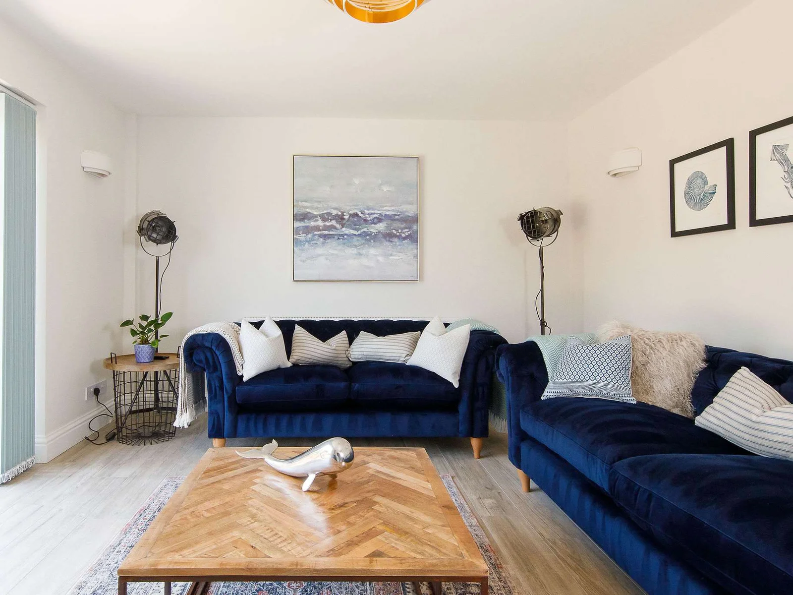 The stylish living room is the perfect place to relax and unwind. Decorated and furnished in a coastal style.