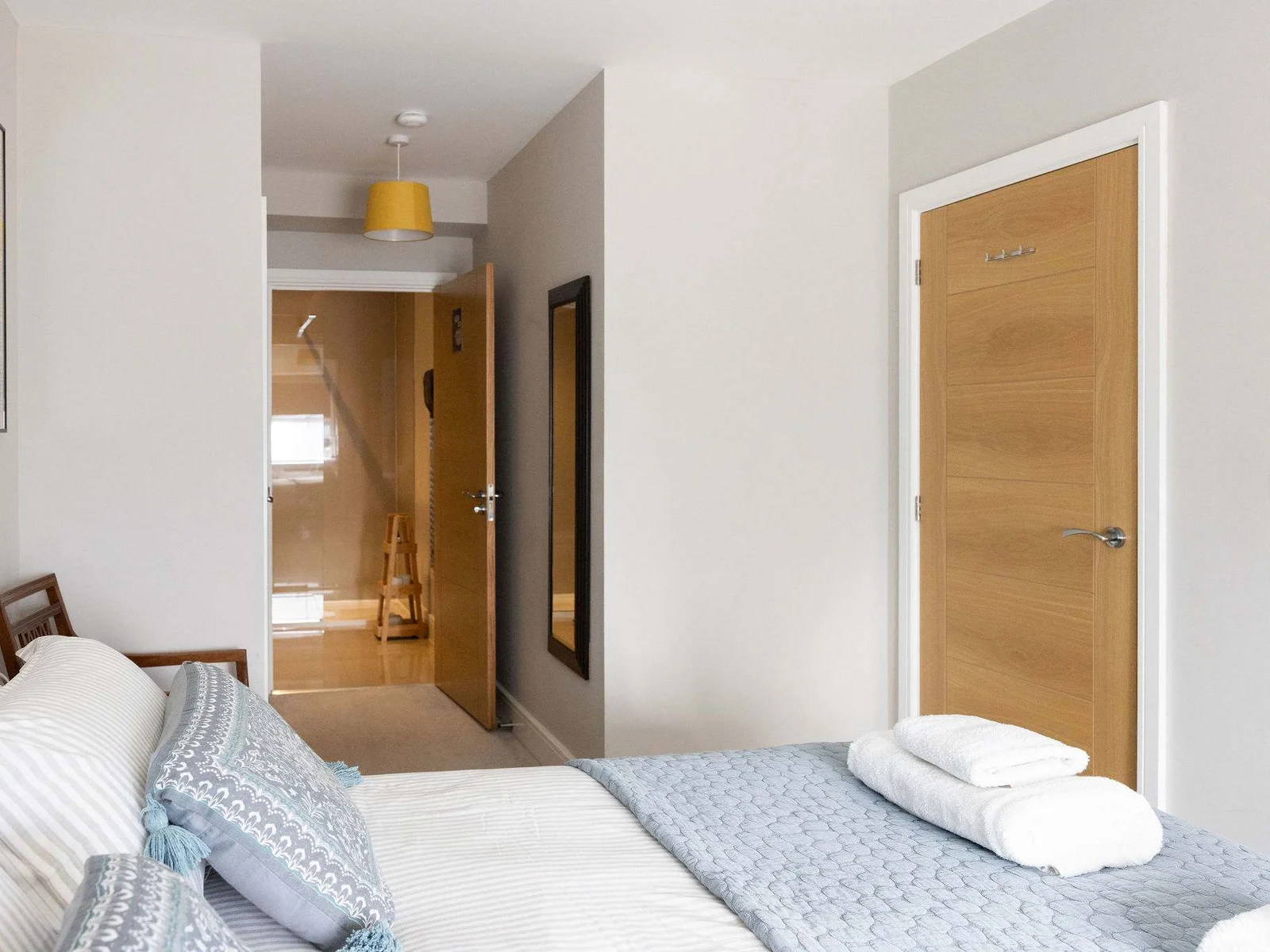 Spacious king bedroom with ensuite access, offering comfort for a relaxing coastal escape