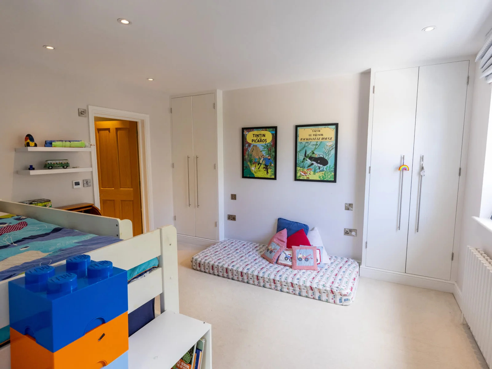Bright kids’ bedroom with bunk bed, built-in wardrobes and cosy reading nook.