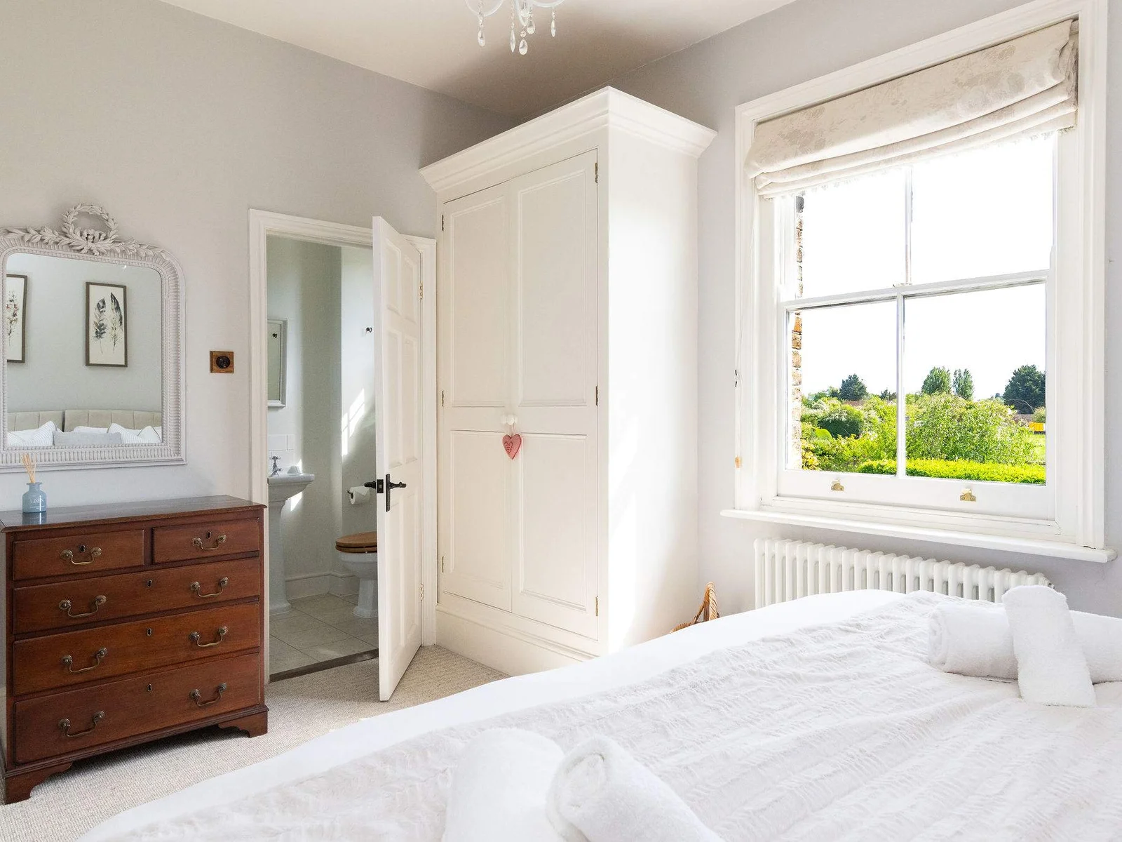 Spacious bedroom with countryside charm and natural light.