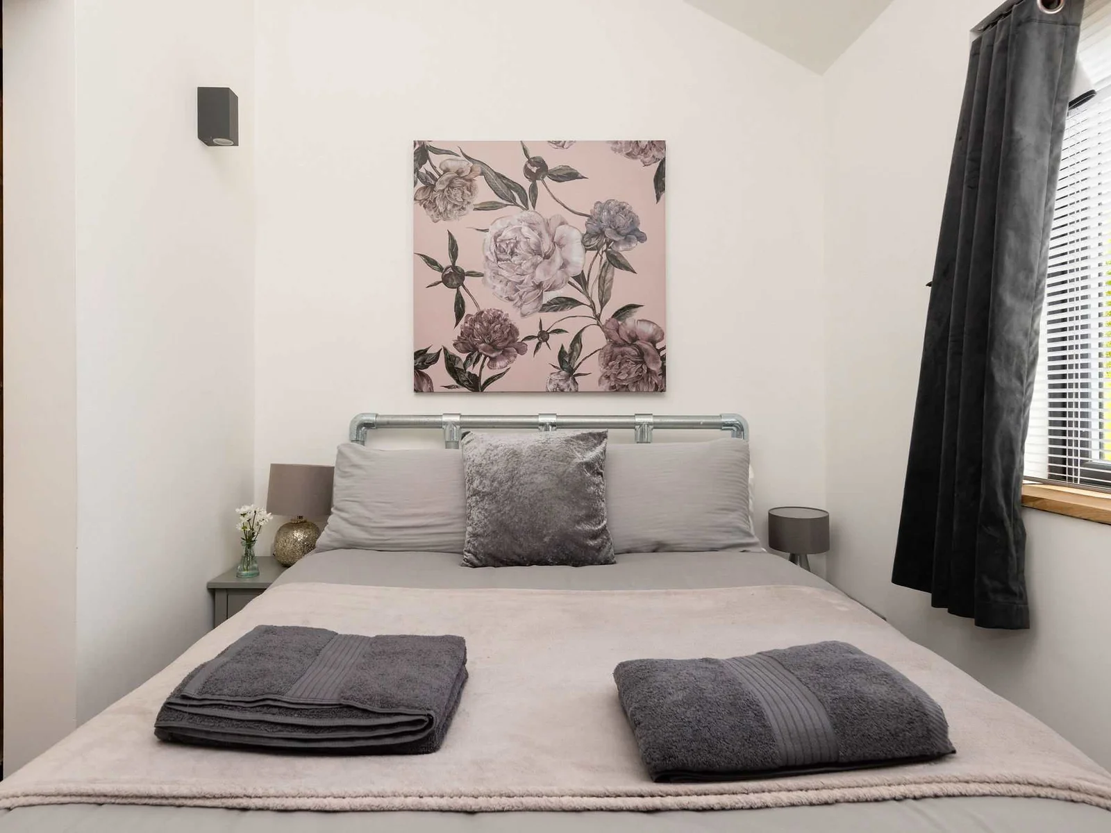 Relax in this tastefully furnished double bedroom featuring cozy bedding and charming rustic details.