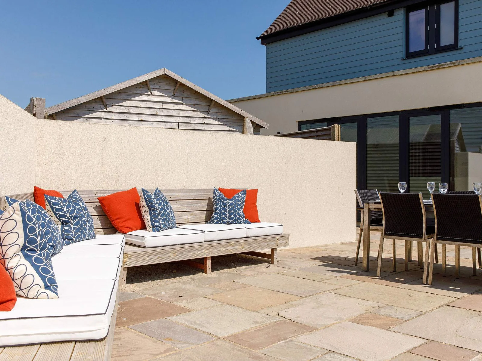 The comfy corner seating at the rear of the home looks out to sea.