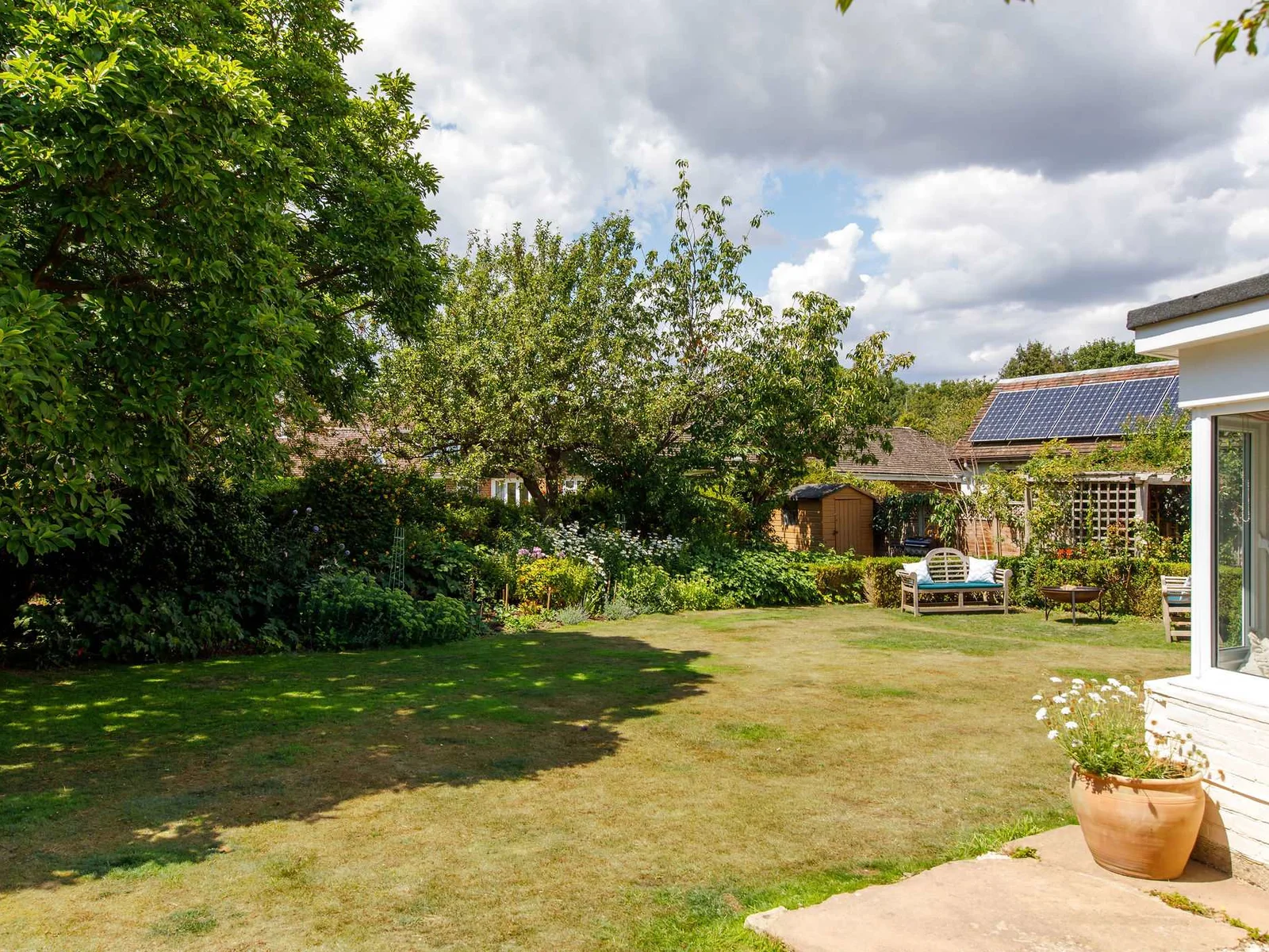 Beautifully cared for back garden, stocked with various plants and flowers