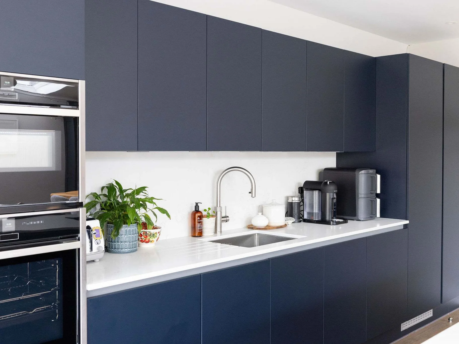 The modern kitchen is fully equipped with state-of-the-art appliances, spacious countertops and ample cabinetry for preparing and cooking.